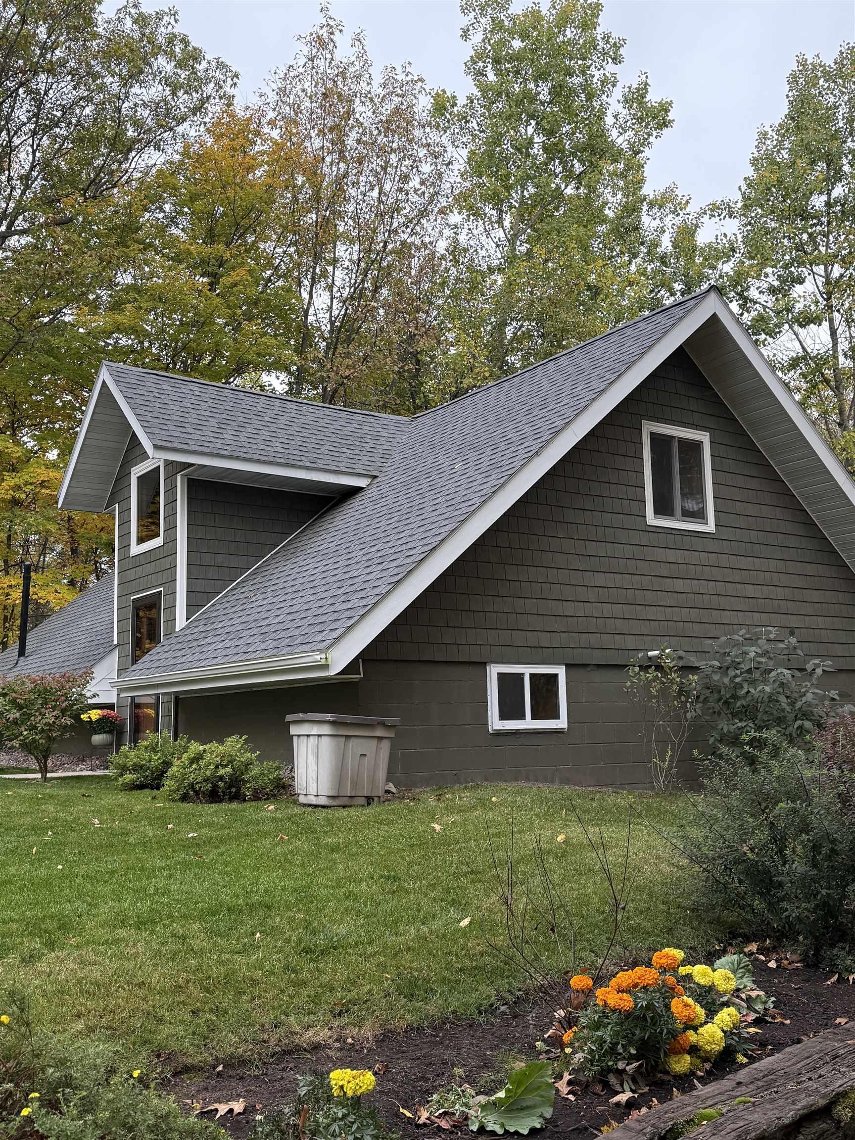 Image 1: View of side of property with roof with shingles and a yard, Side Of Structure