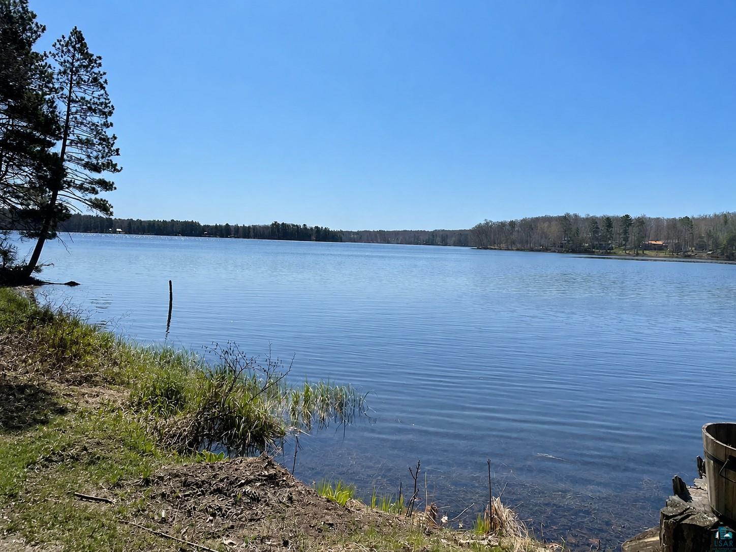 Image 3: Expansive lakefront with clear water and a natural shoreline, View