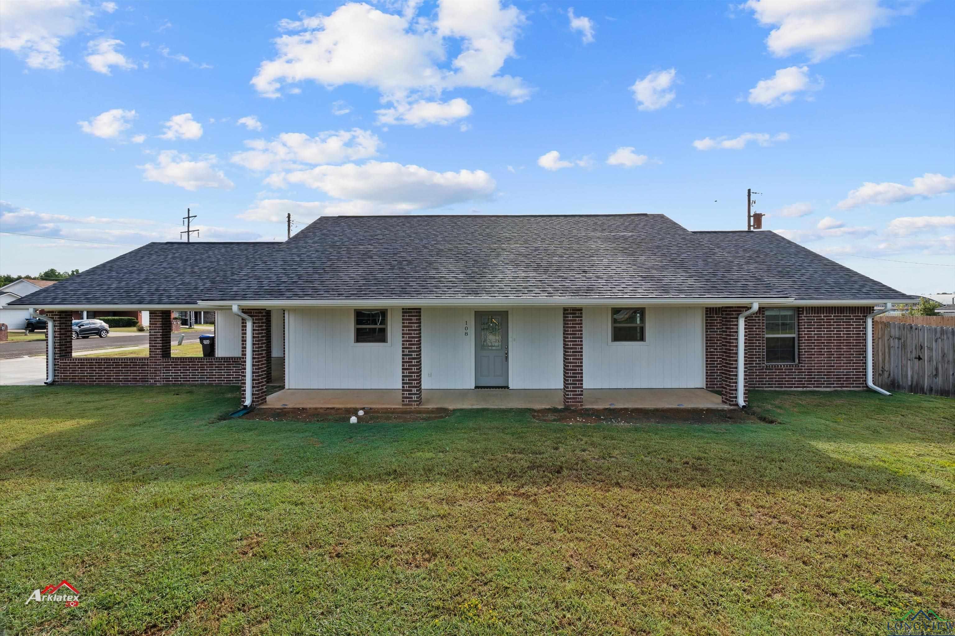 Image 0: Back of house featuring covered porch, a yard, roof with shingles, and fence, Back Of Structure