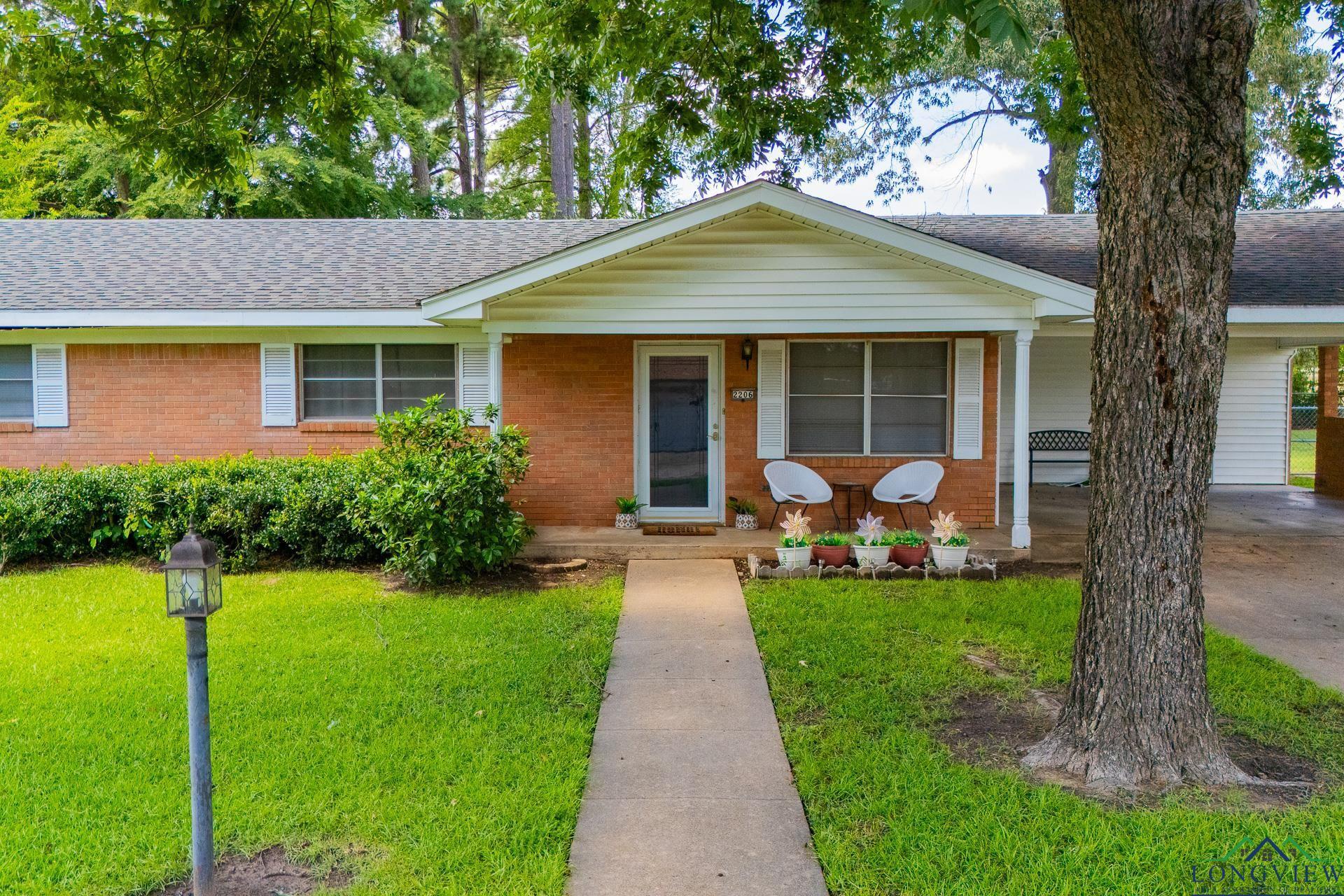 Image 1: Ranch-style house featuring roof with shingles, a front yard, covered porch, and brick siding, Front Of Structure