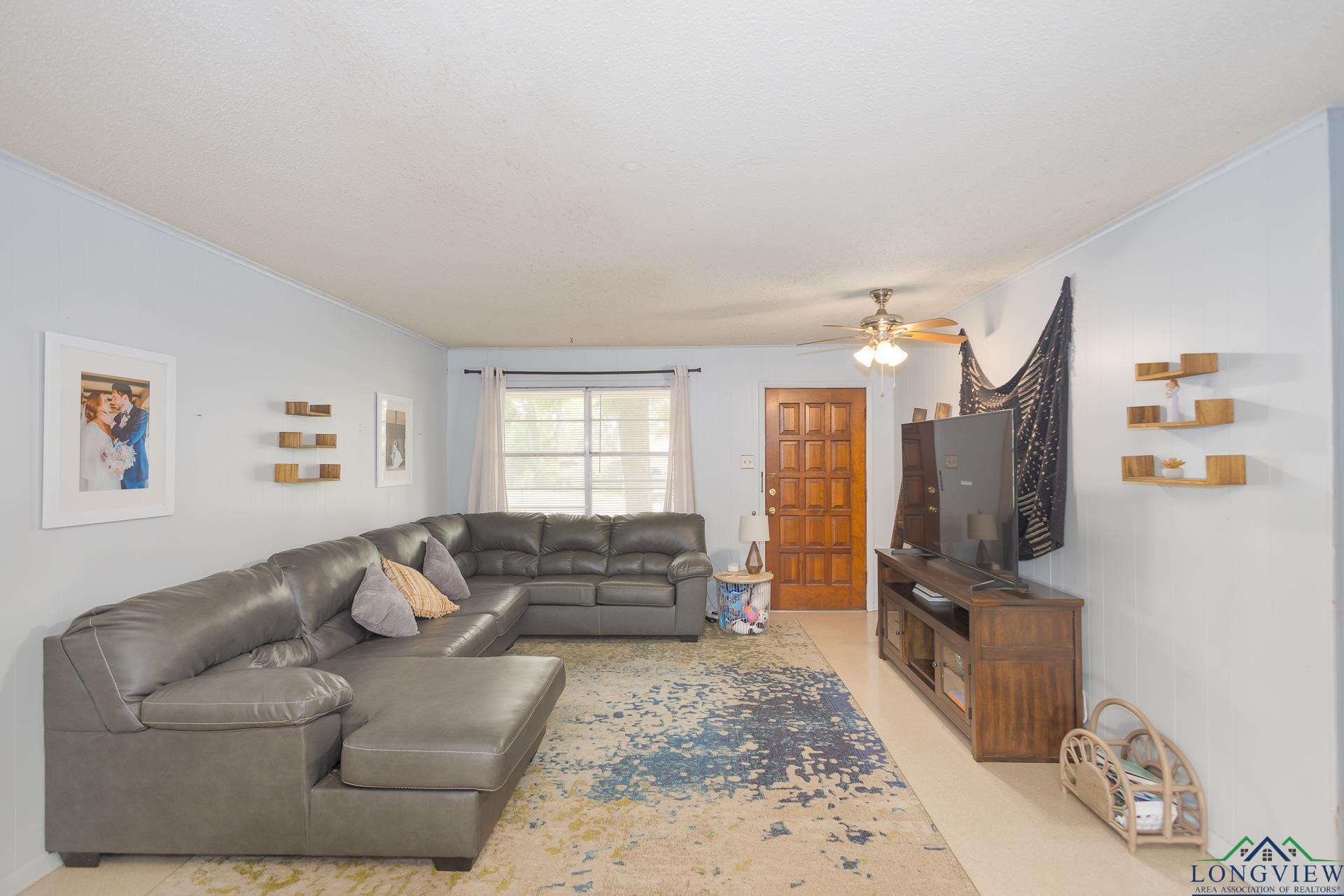 Image 2: Living area featuring a ceiling fan and crown molding, Living Room
