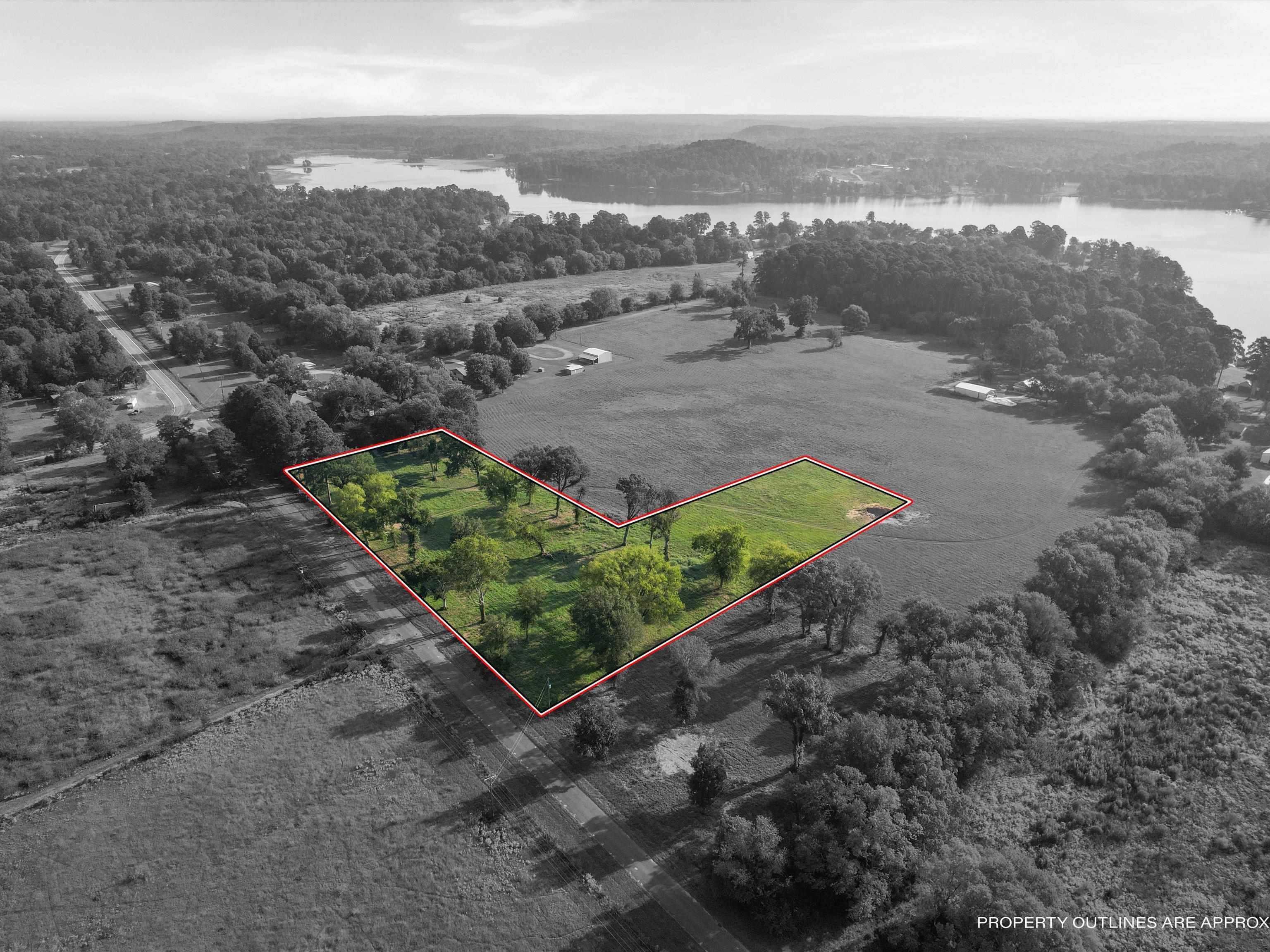 Image 3: Aerial overview of property's location featuring property boundaries highlighted and a large body of water, Aerial View