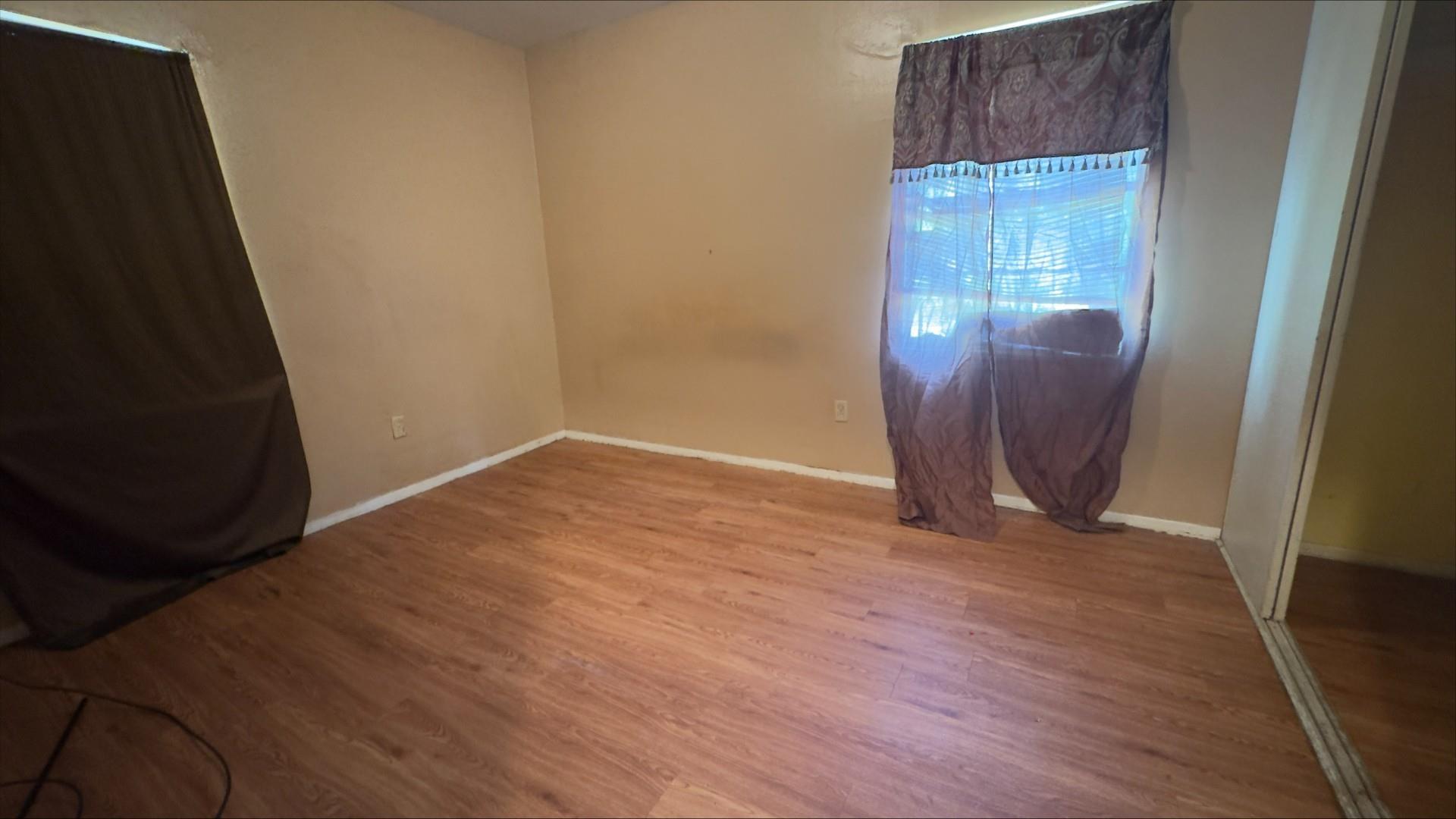 Image 2: Room featuring wood-finish flooring and neutral wall paint, Other