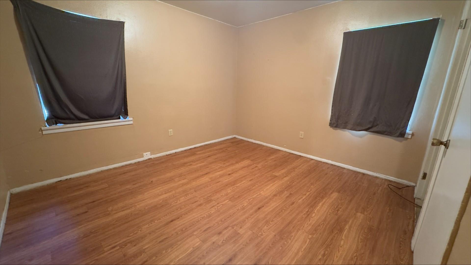 Image 3: Bright interior space featuring wood-finish flooring, light-toned wall paint, and white baseboards, Other