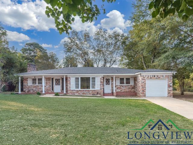 Image 1: Ranch-style house with a garage, a chimney, a front lawn, brick siding, and concrete driveway, Front Of Structure