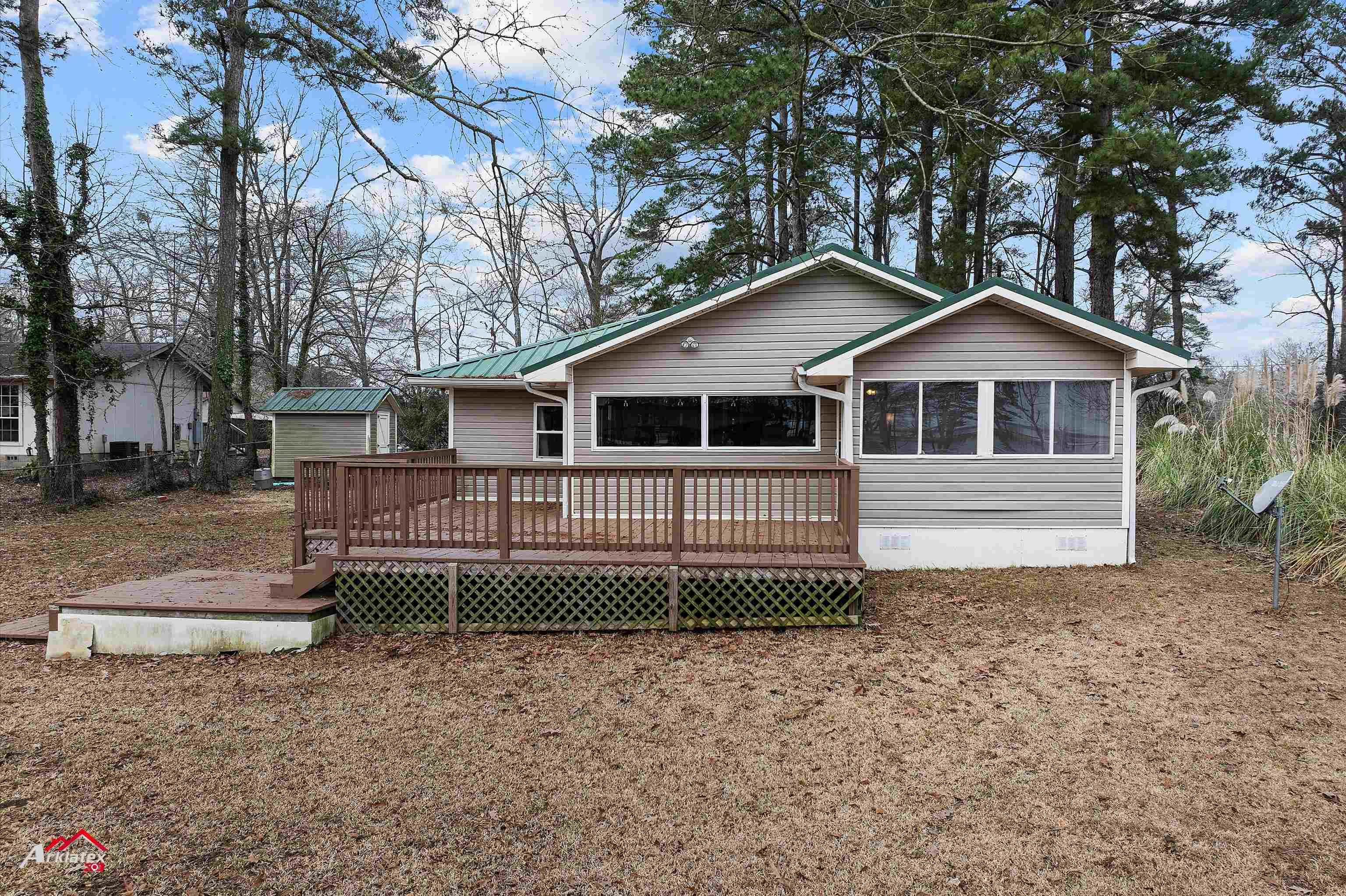 Image 0: Back of property featuring a wooden deck and a shed, Back Of Structure