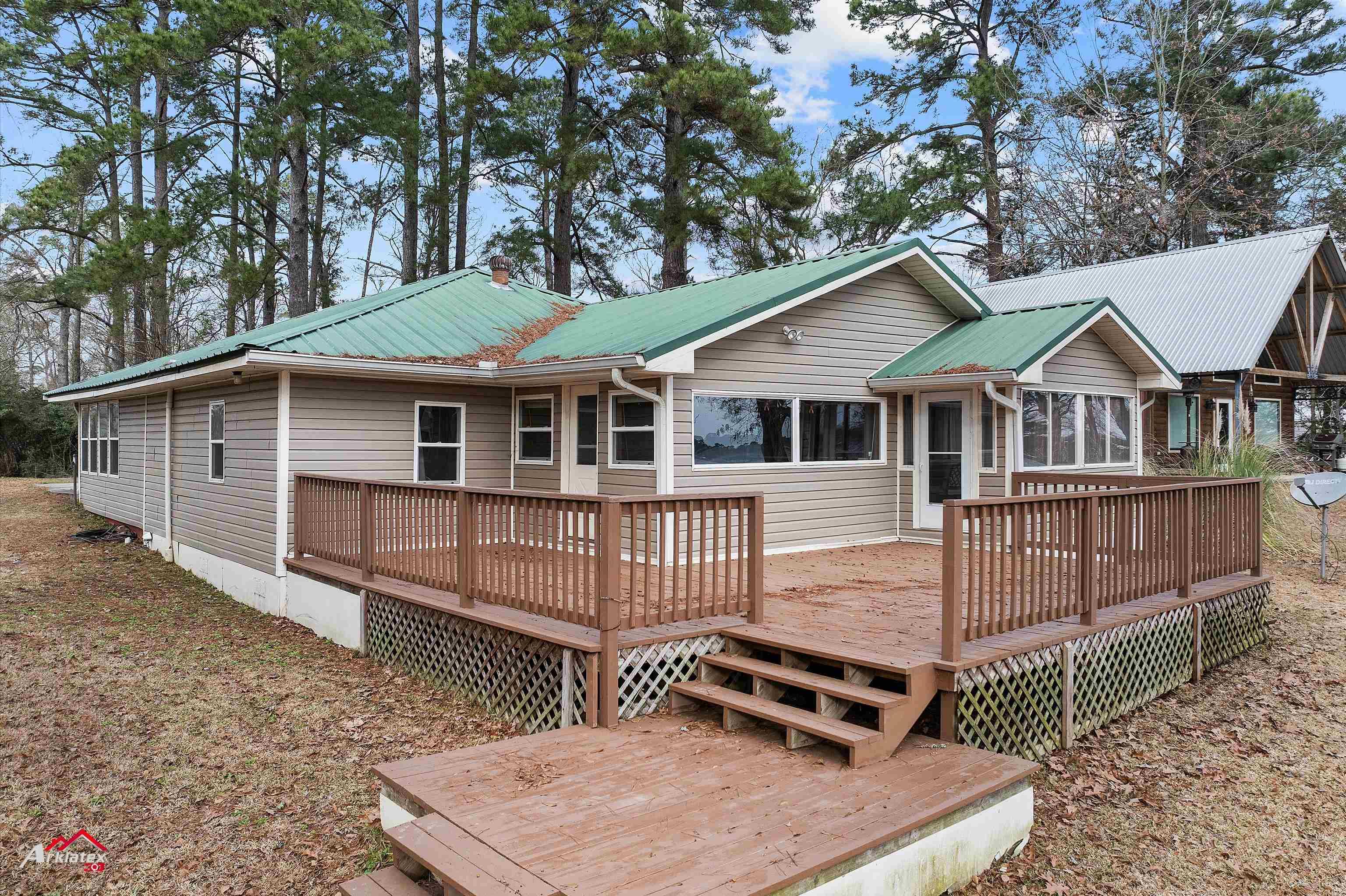 Image 1: Rear view of property featuring a deck, Back Of Structure