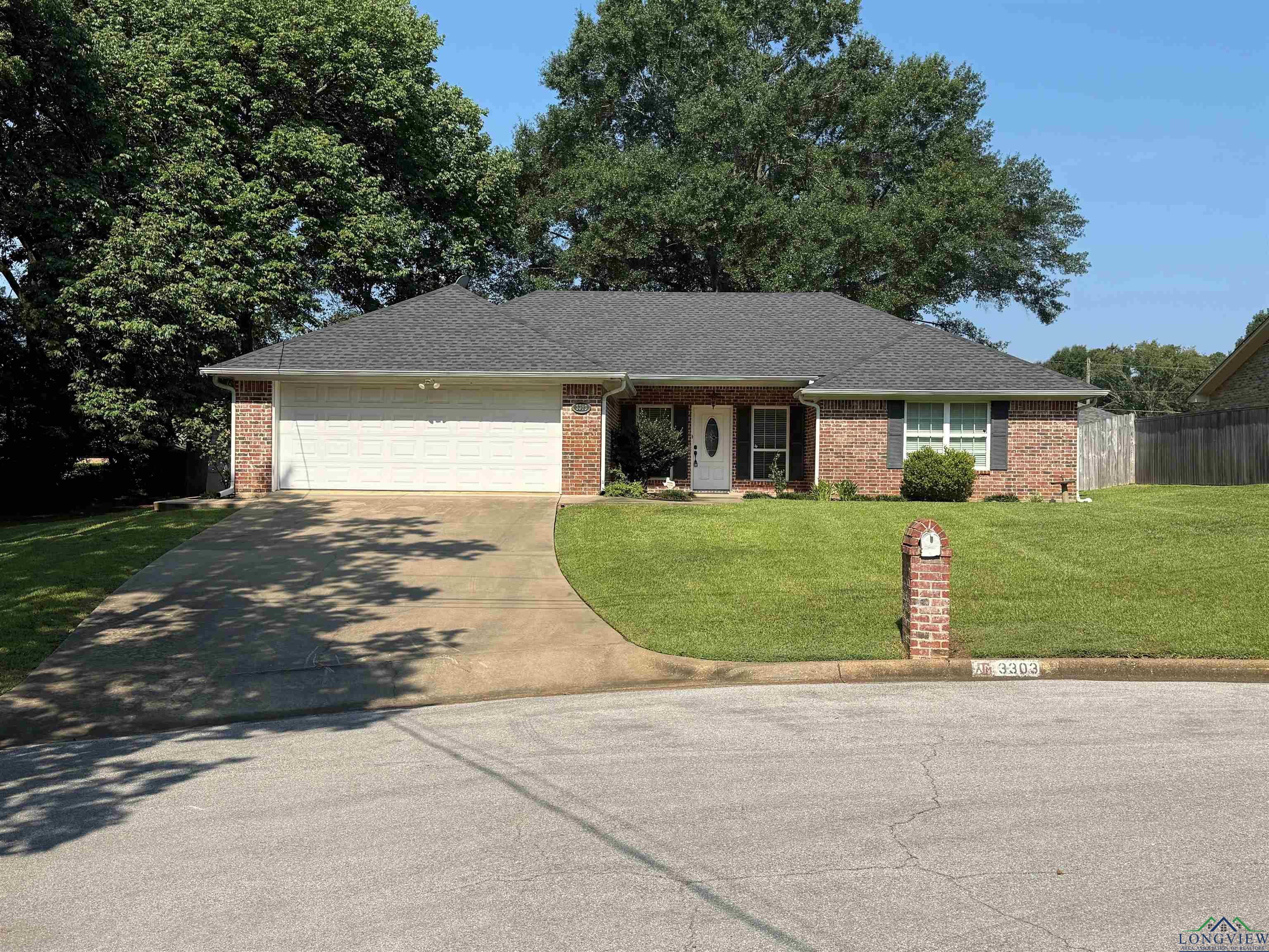 Image 0: Single story home featuring driveway, a garage, brick siding, and a shingled roof, Front Of Structure
