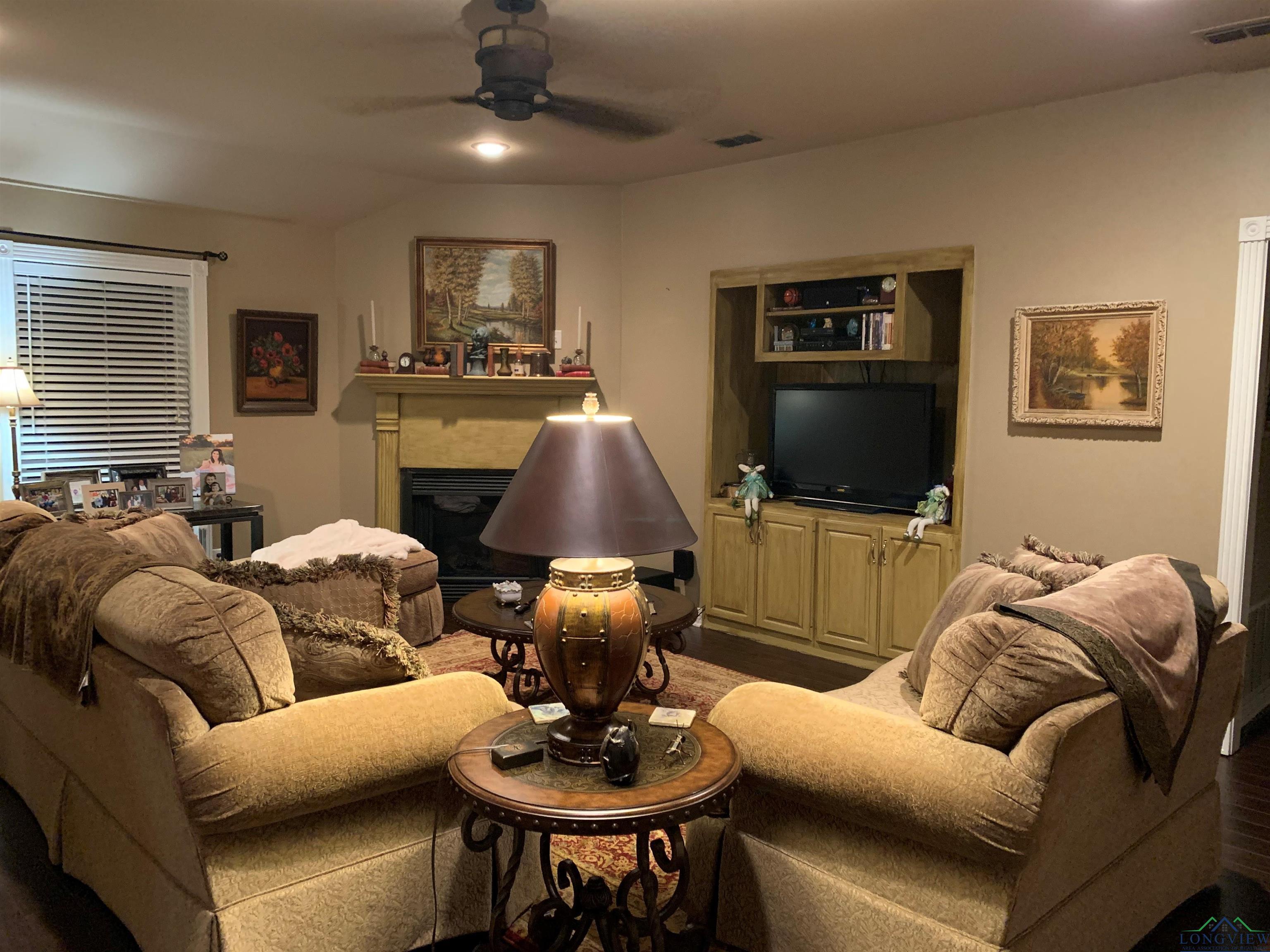 Image 2: Living room with ceiling fan and wood-type flooring, Living Room