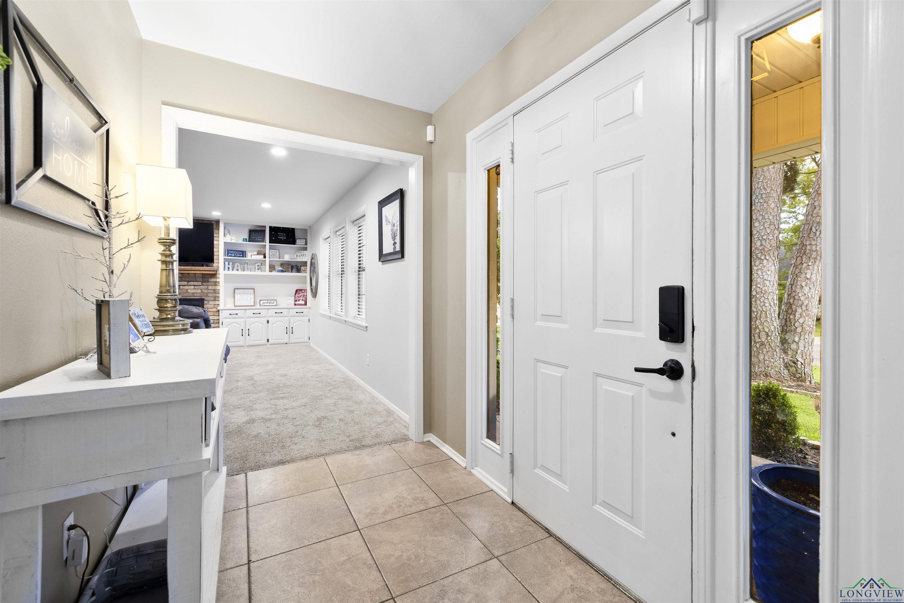 Image 3: Entryway with light colored carpet, light tile patterned flooring, and recessed lighting, Entrance Foyer