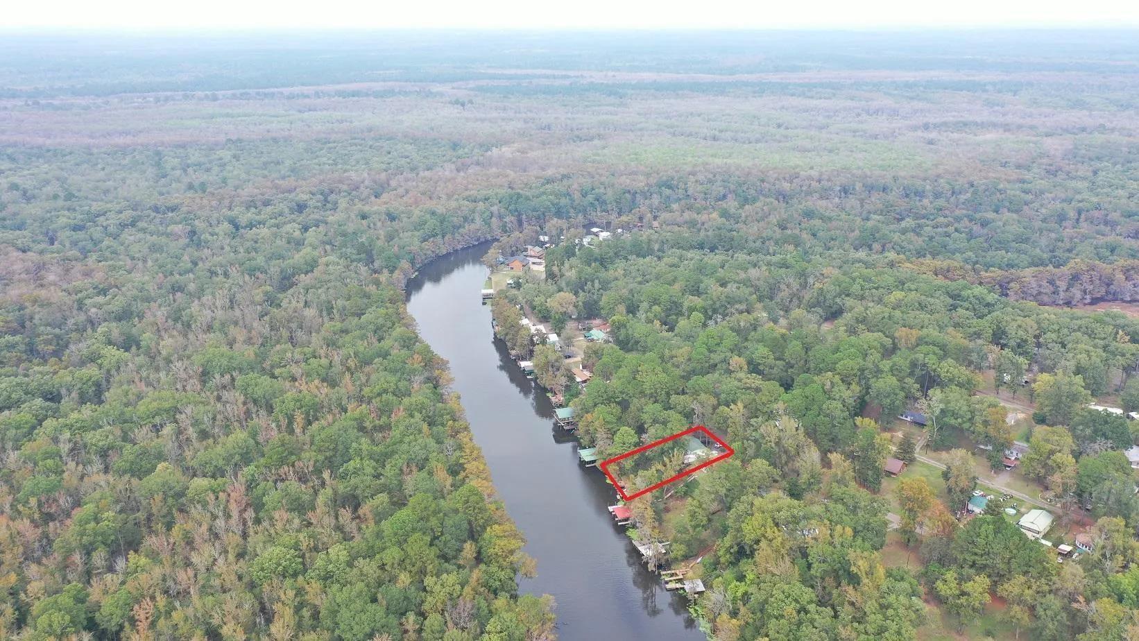 Image 2: View of property location with a large body of water and property parcel outlined, Aerial View