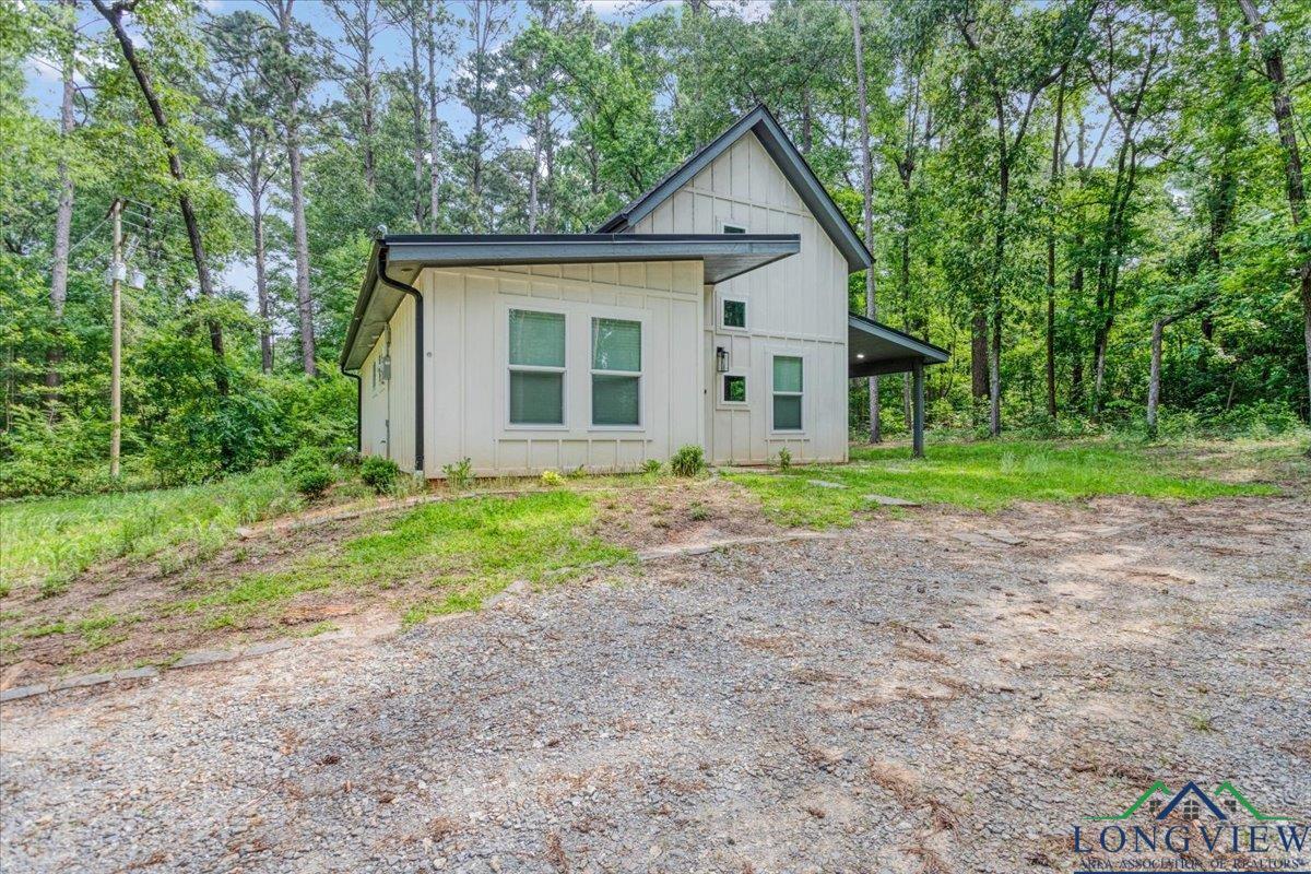 Image 2: View of front of property featuring board and batten siding, Front Of Structure
