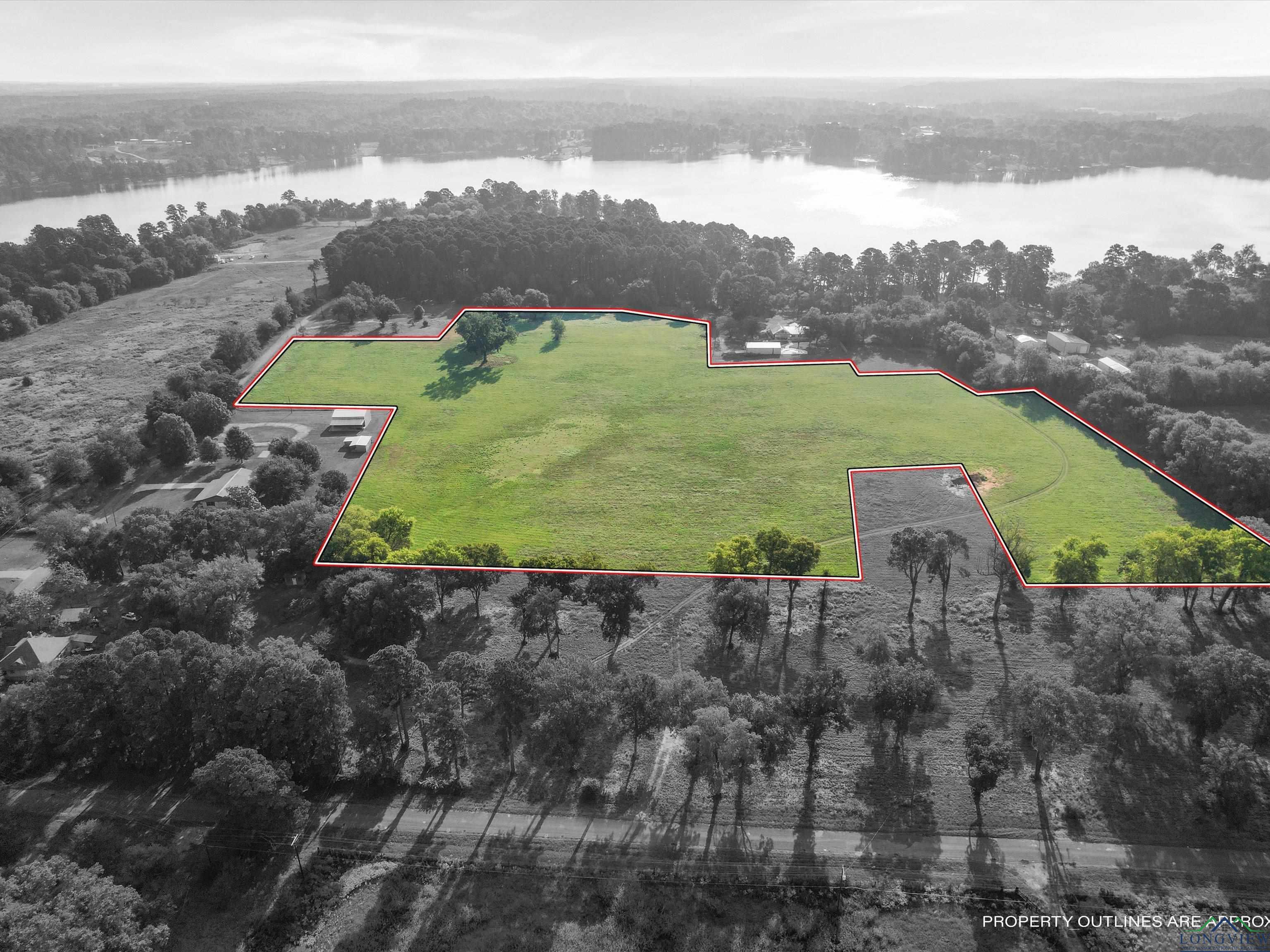 Image 0: View of property location featuring a nearby body of water and property boundaries highlighted, Aerial View