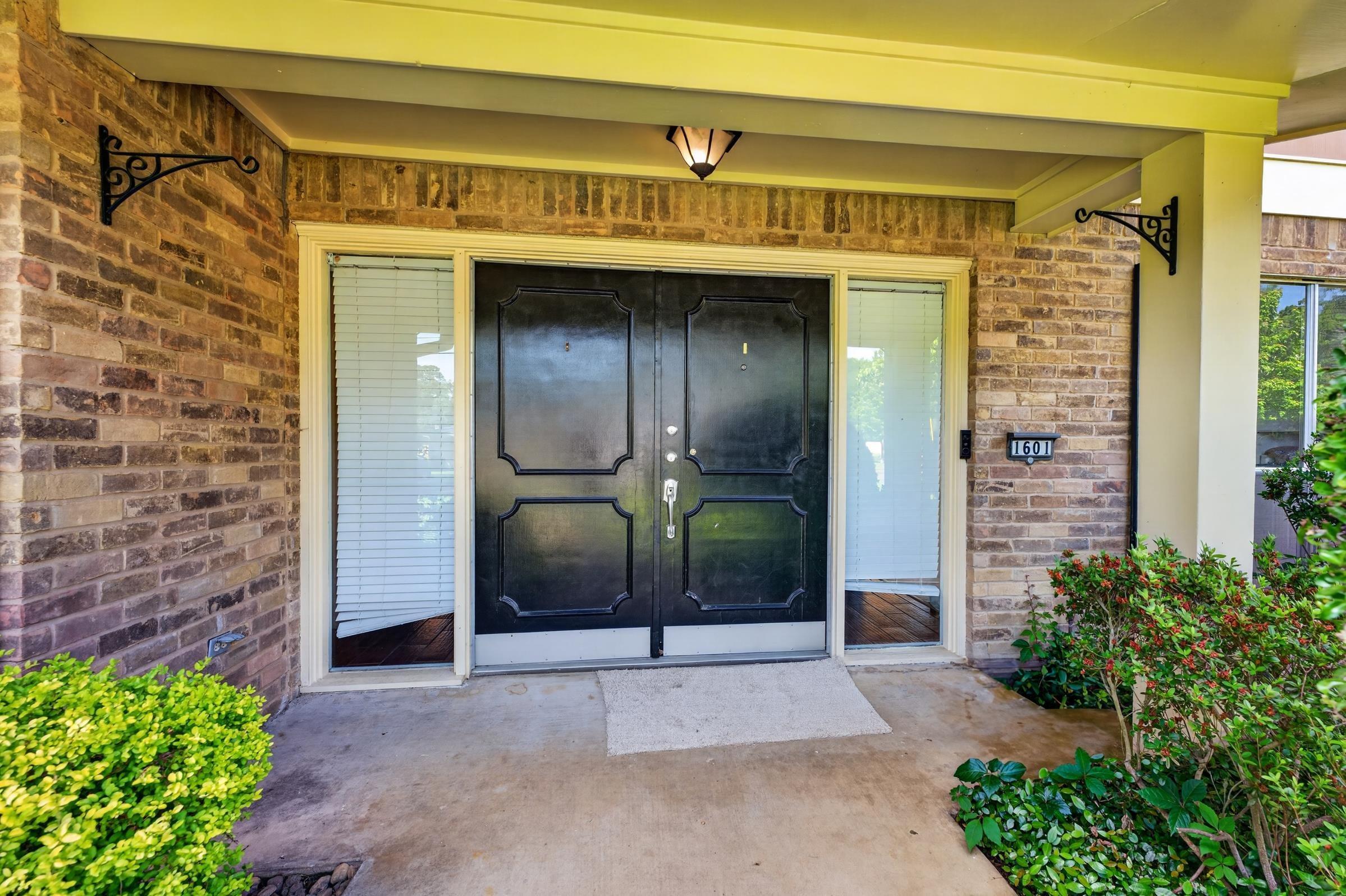 Image 1: Brick facade entry with a covered porch, Entry
