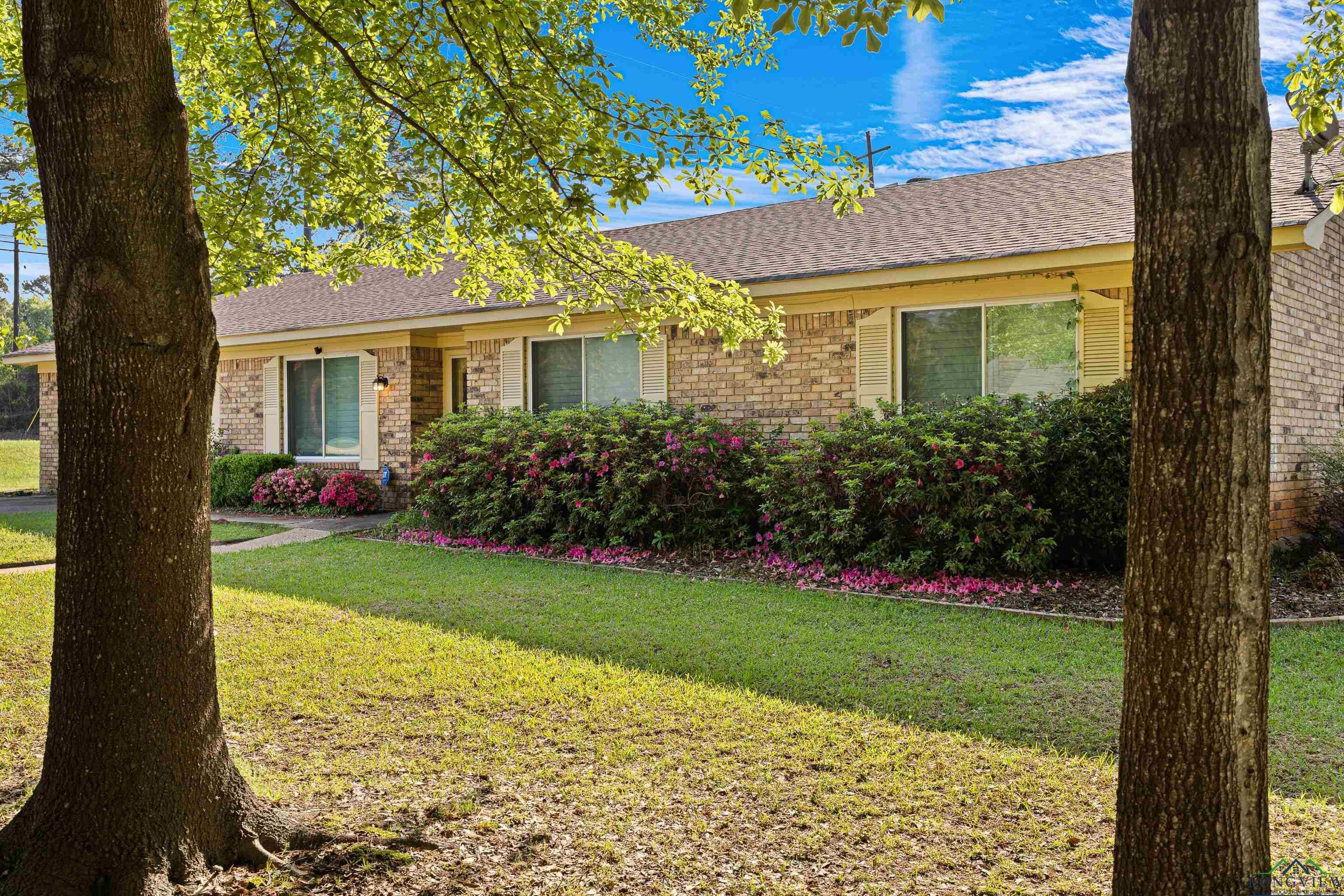 Image 1: Single story home featuring a shingled roof, brick siding, and a front lawn, Front Of Structure