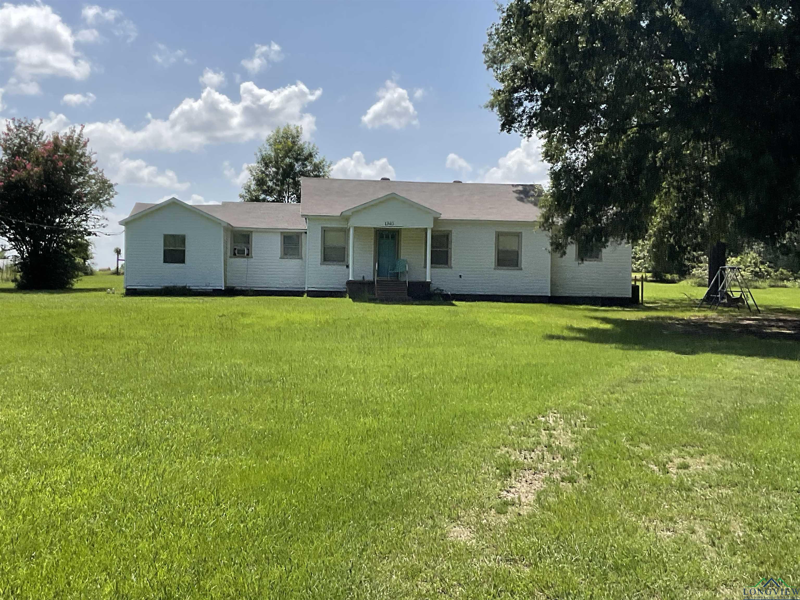 Image 1: Ranch-style house with a front lawn, Front Of Structure