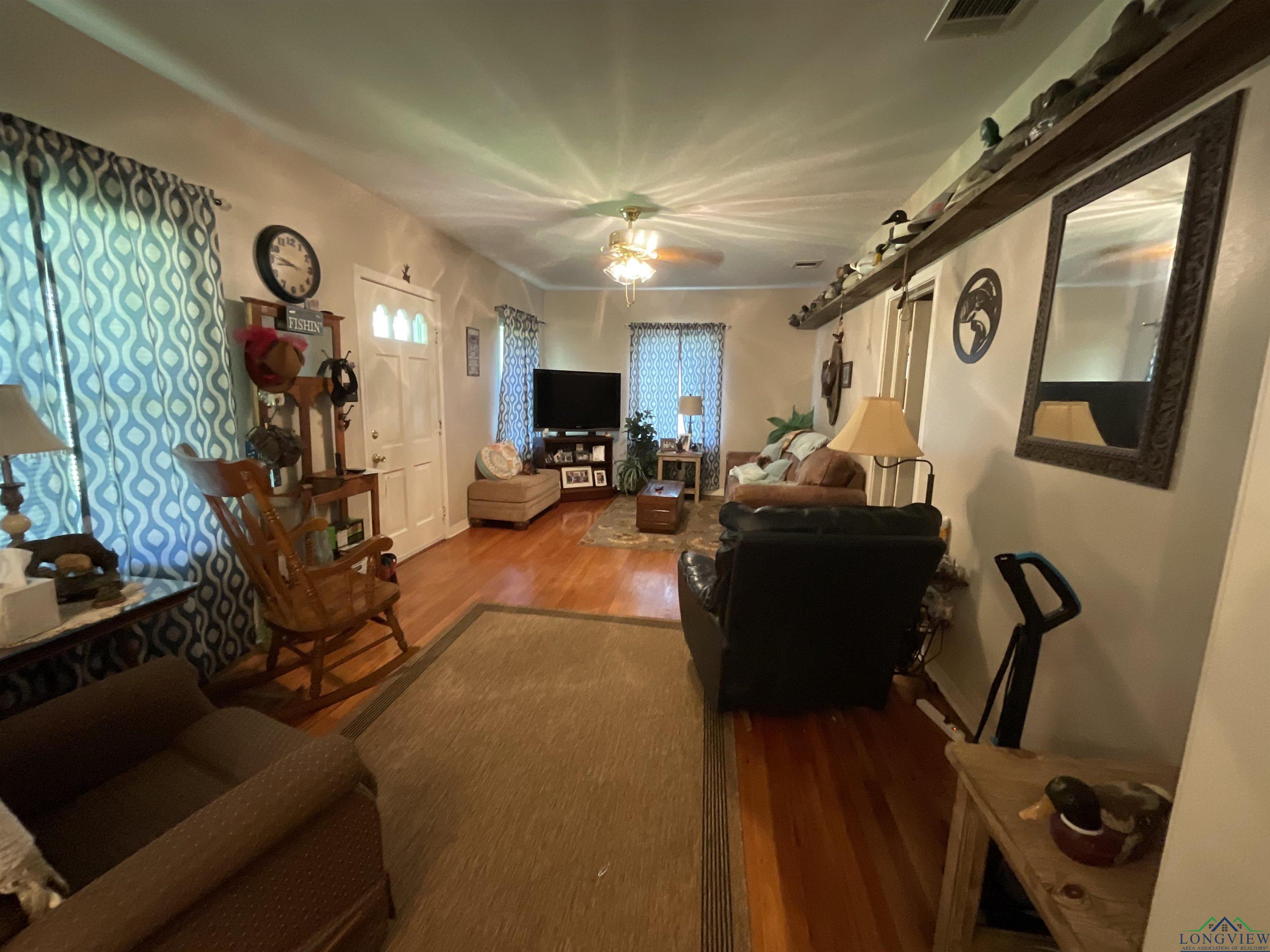 Image 2: Living area featuring wood finished floors and a ceiling fan, Living Room