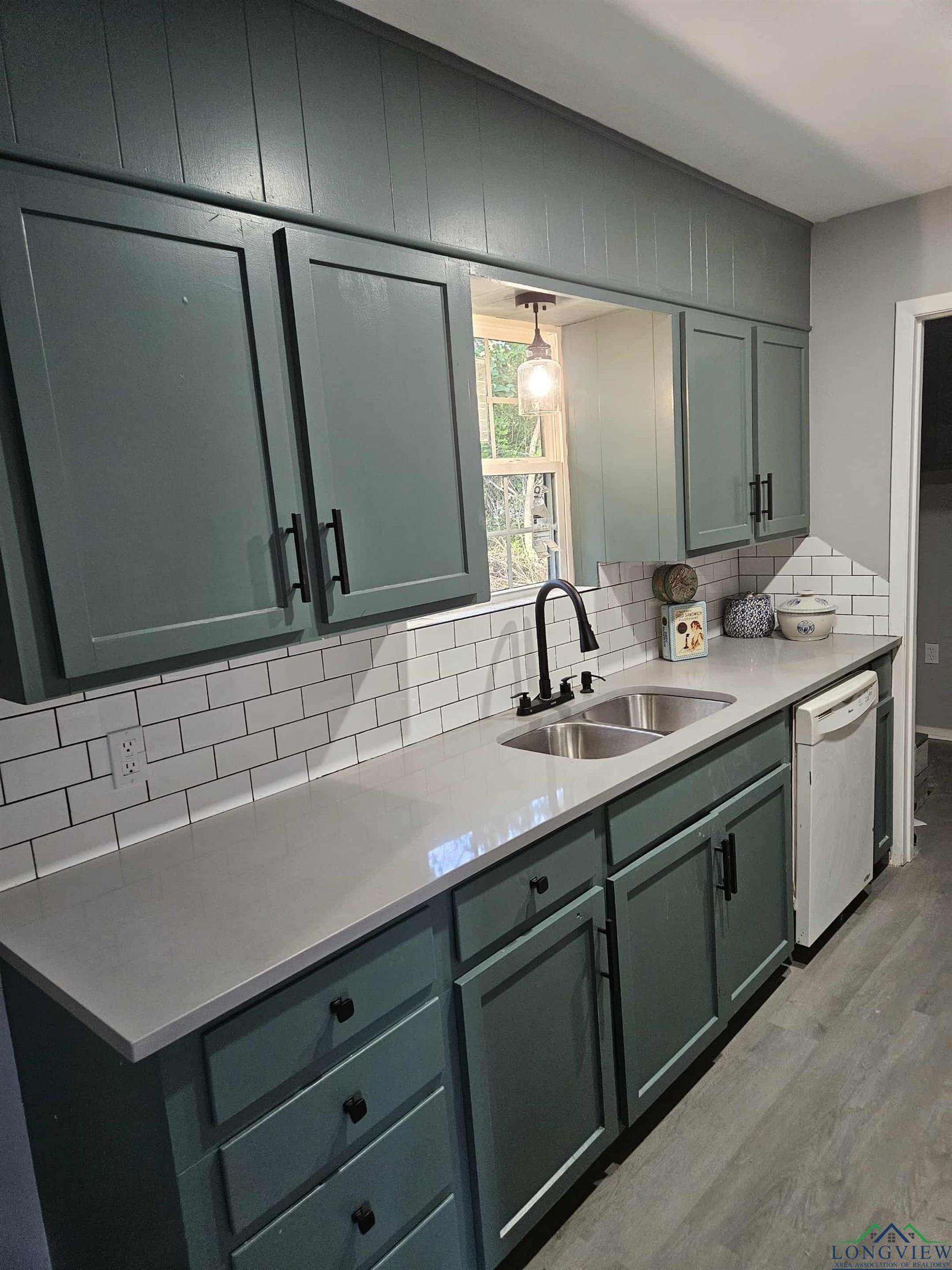 Image 0: Kitchen featuring decorative backsplash, light wood-style flooring, light stone counters, and dishwasher, Kitchen