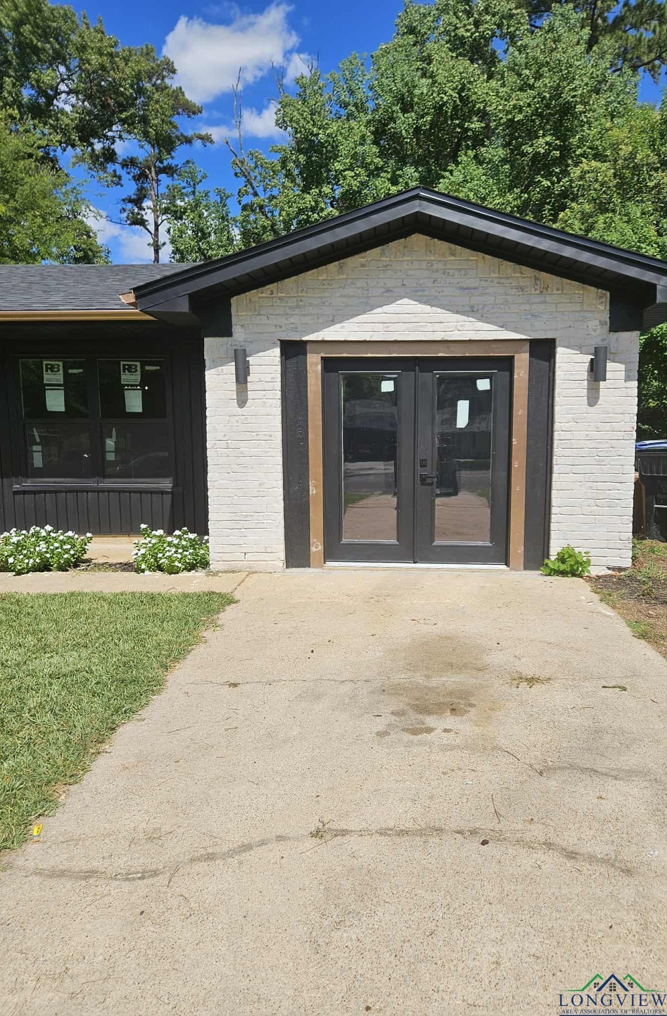 Image 3: Entrance to property featuring french doors and brick siding, Entry