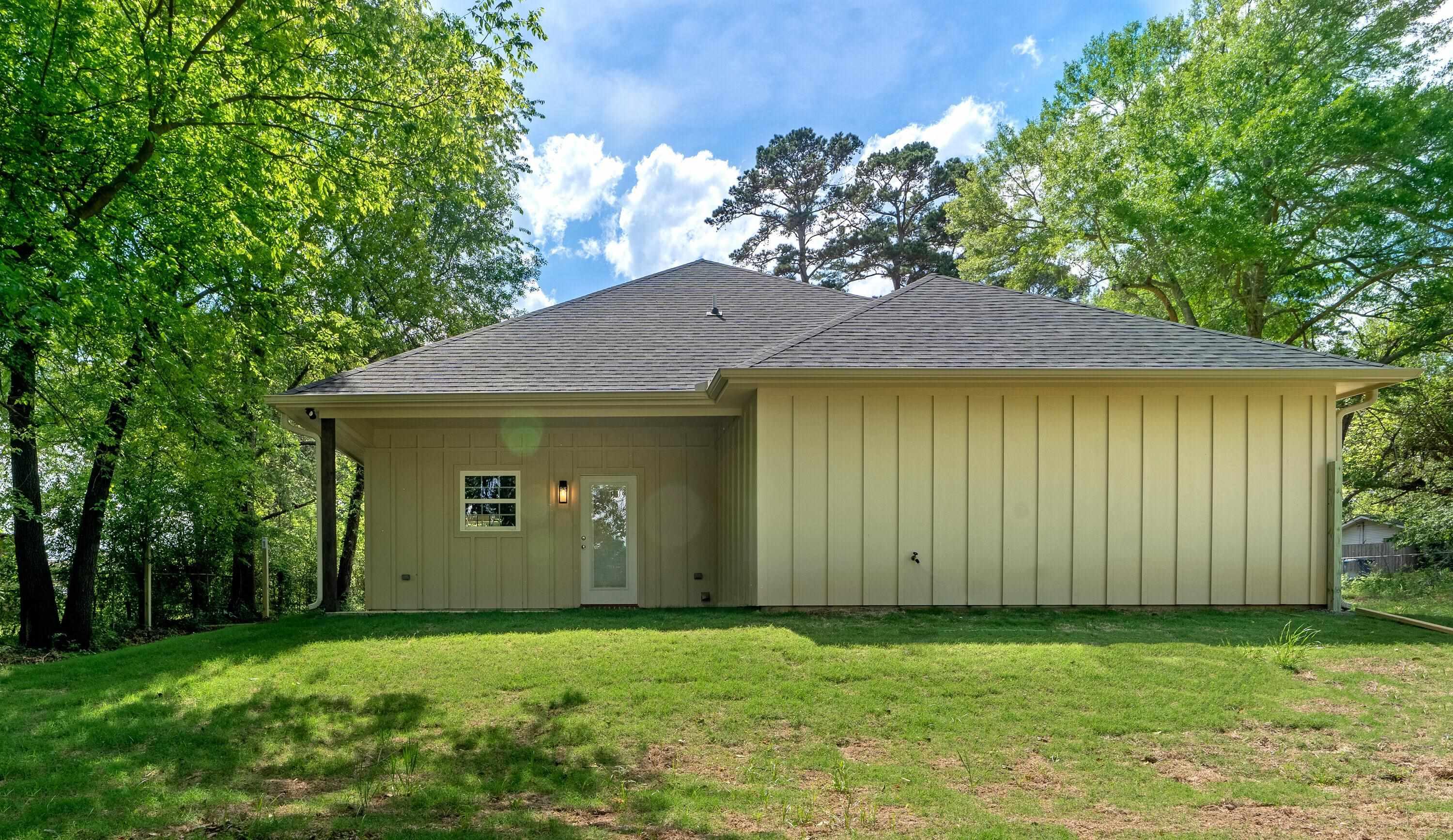 Image 2: Rear view of property featuring a lawn and roof with shingles, Back Of Structure