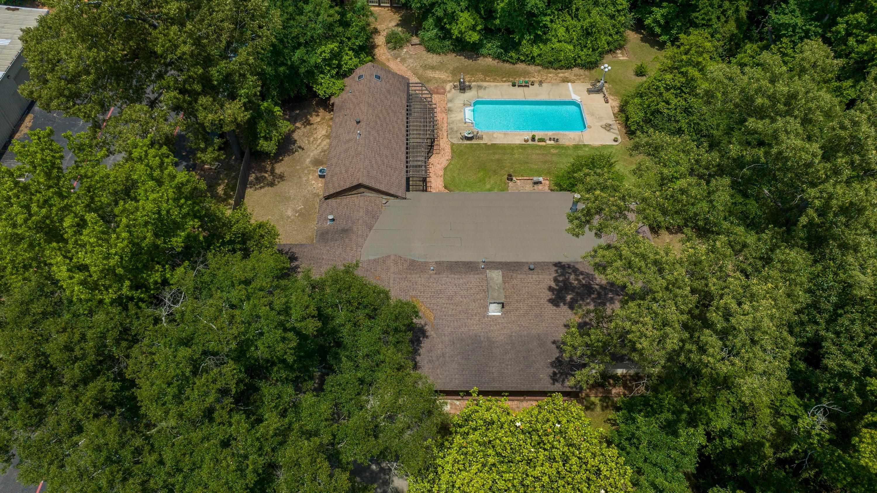 Image 1: Residence with a shingled roof and an irregular footprint, Aerial View