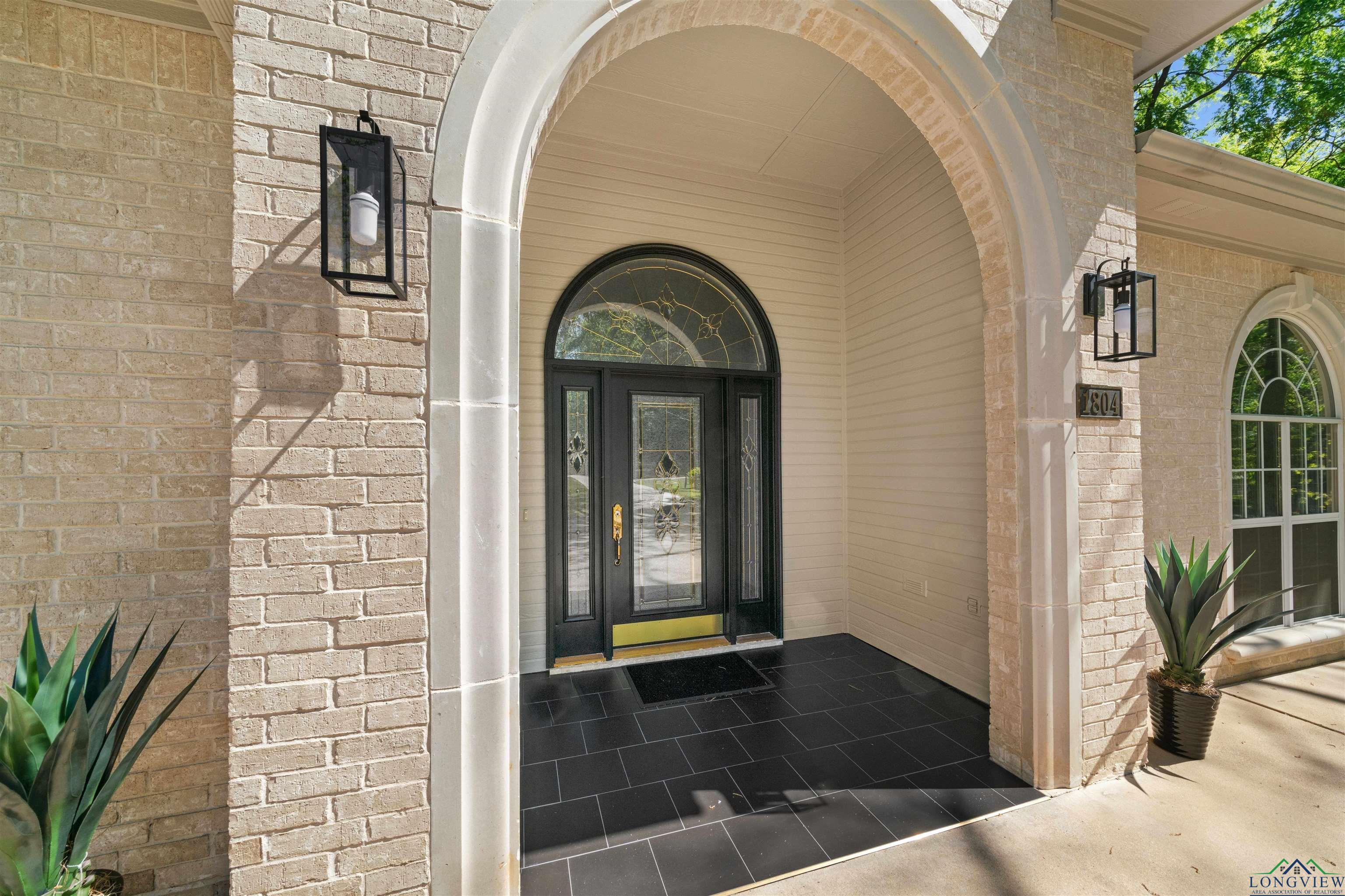 Image 3: Doorway to property featuring brick siding, Entry