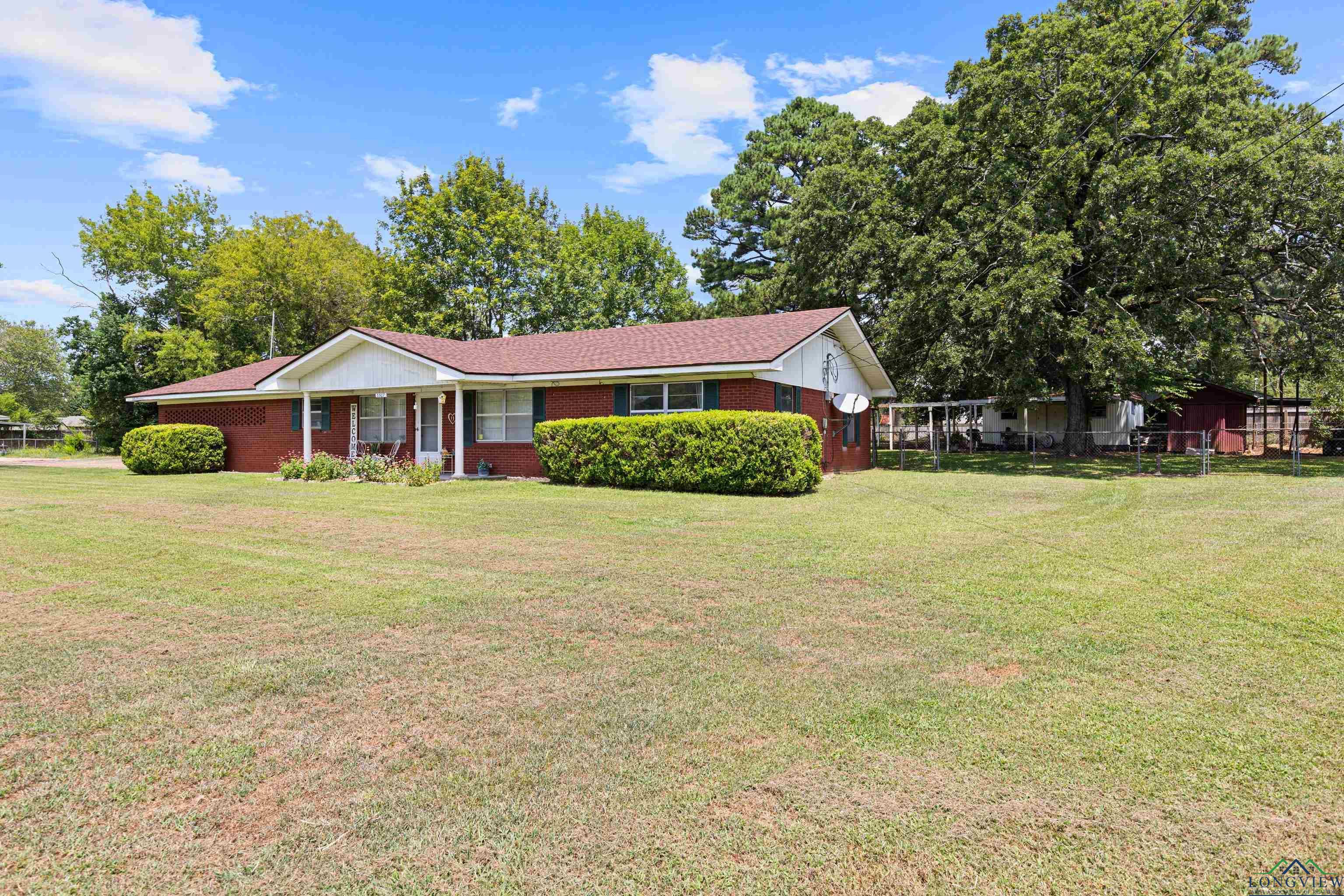 Image 1: Ranch-style home with brick siding, Front Of Structure