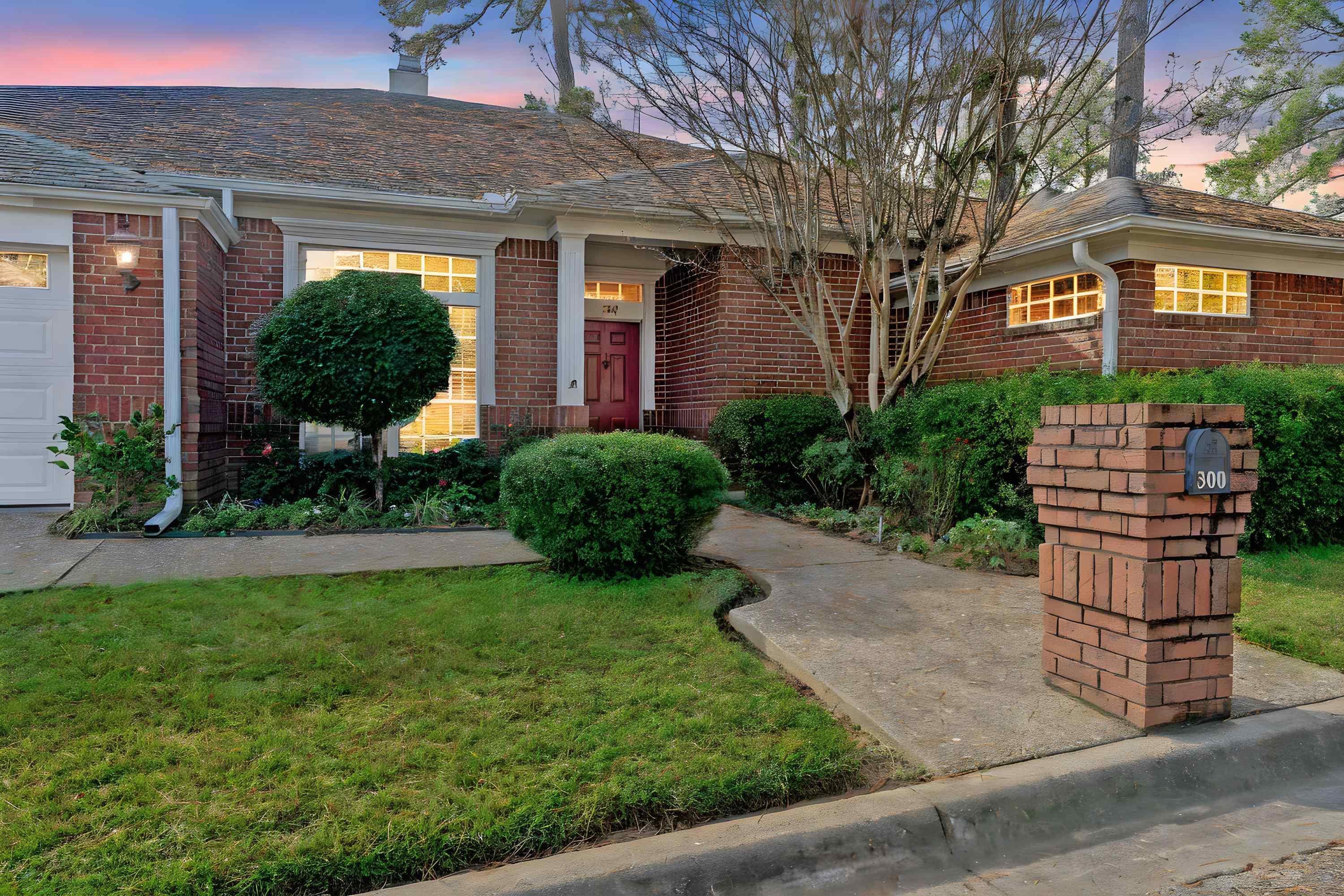 Image 2: Single story home featuring a front yard, brick siding, and a chimney, Front Of Structure