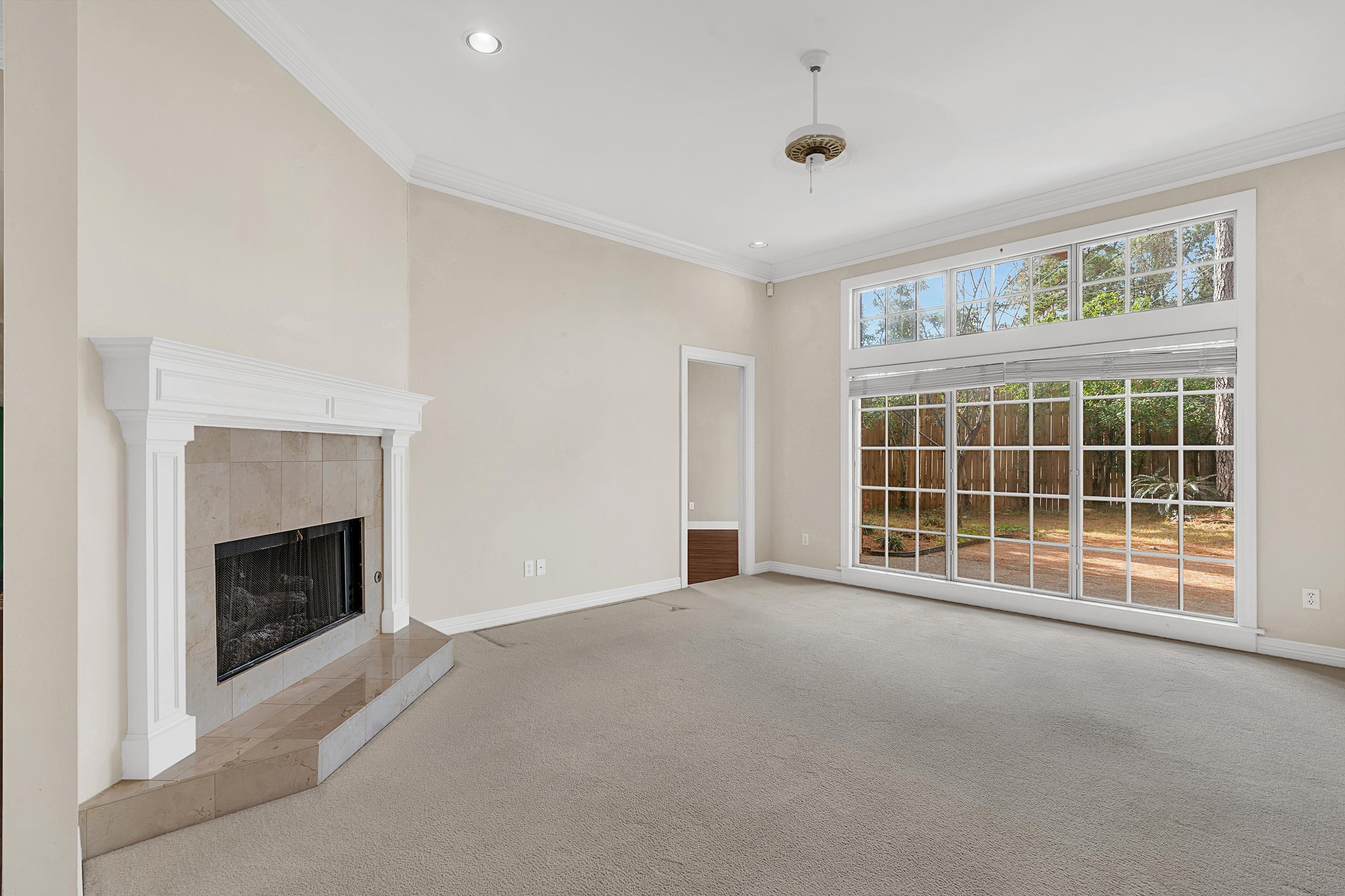 Image 3: Unfurnished living room with a tile fireplace, carpet, ornamental molding, and recessed lighting, Living Room