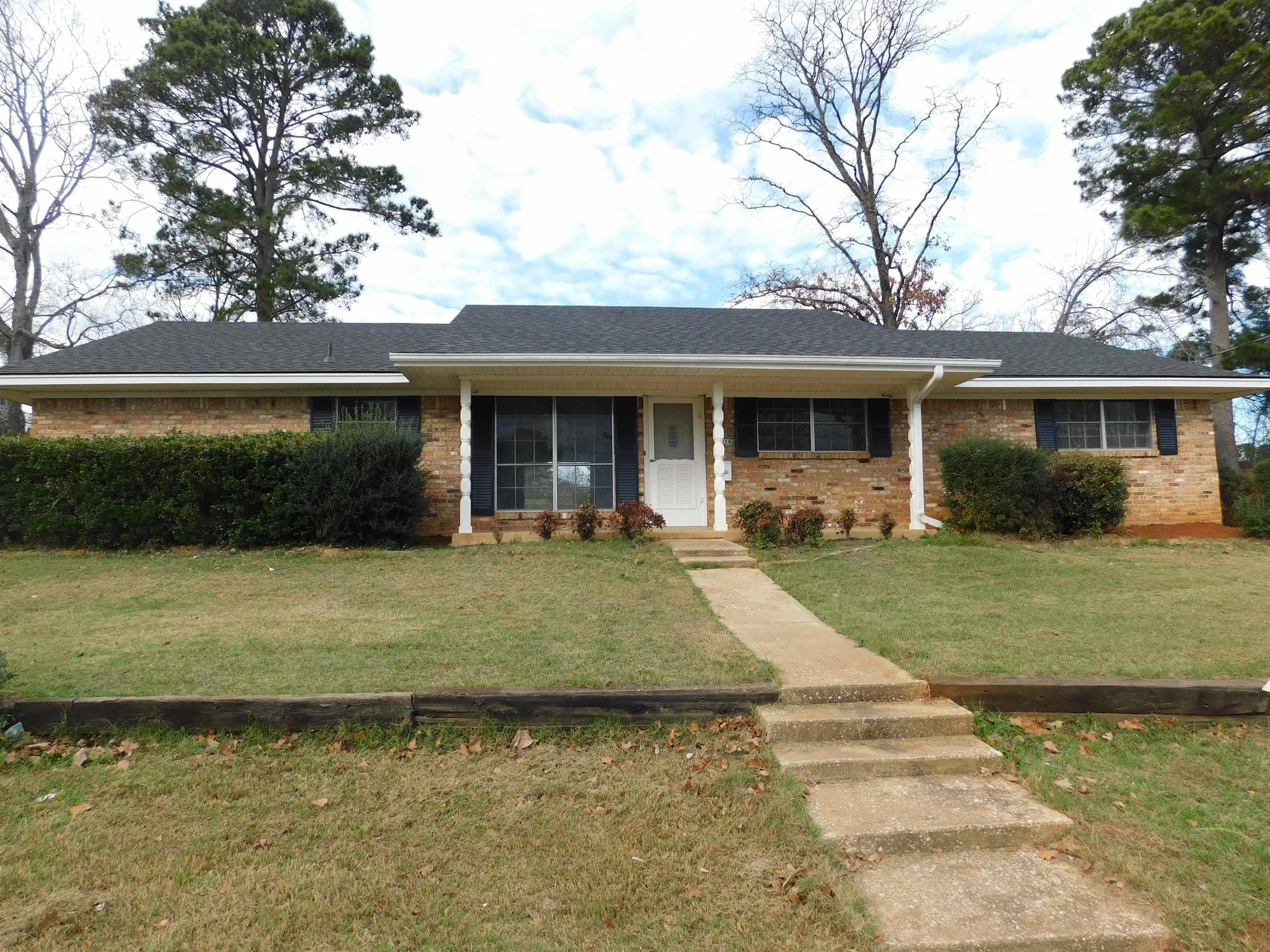 Image 0: Ranch-style house featuring covered porch, a front lawn, brick siding, and roof with shingles, Front Of Structure
