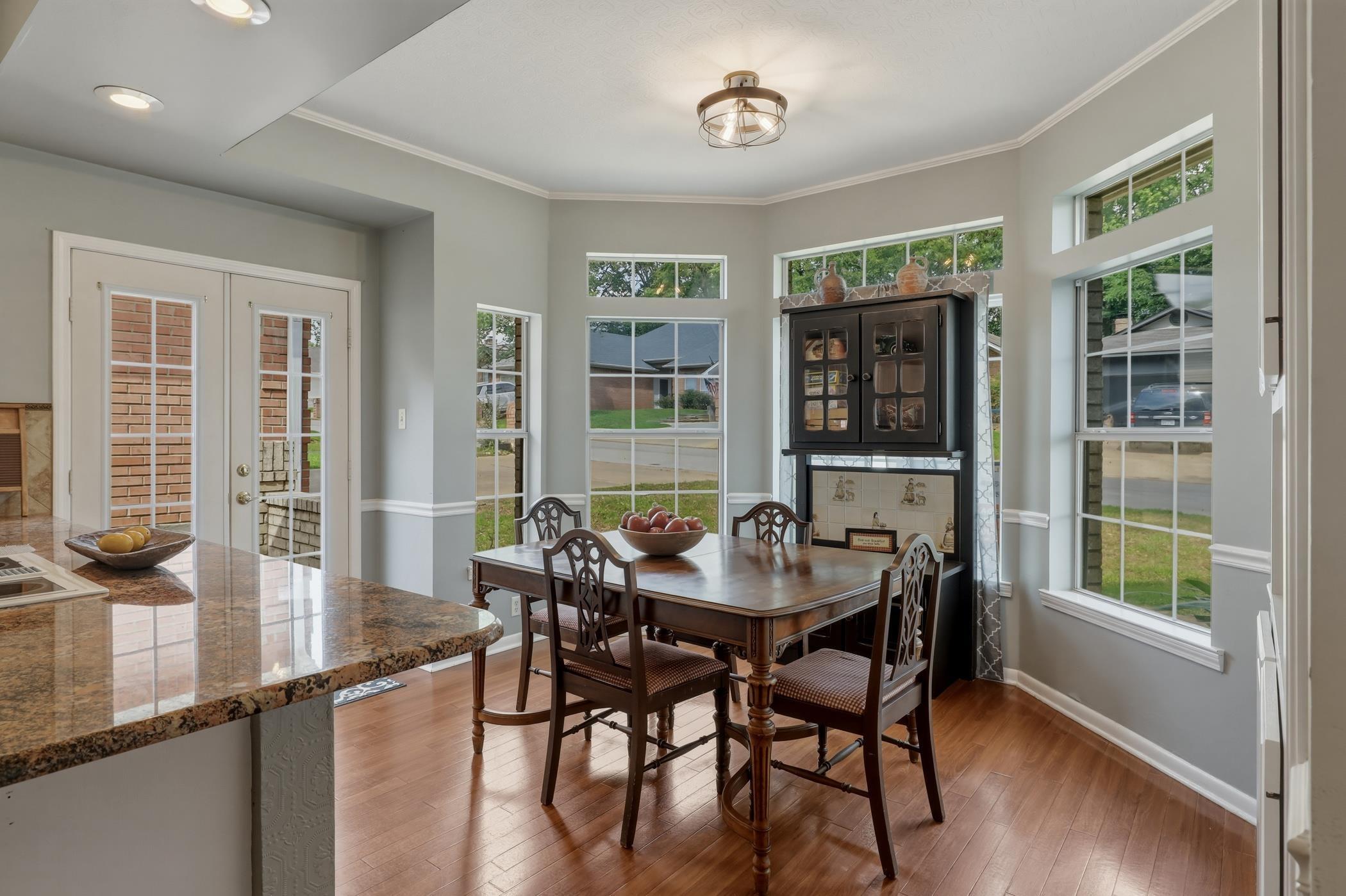Image 2: Dining room featuring ornamental molding, hardwood / wood-style flooring, french doors, and plenty of natural light, Dining Area
