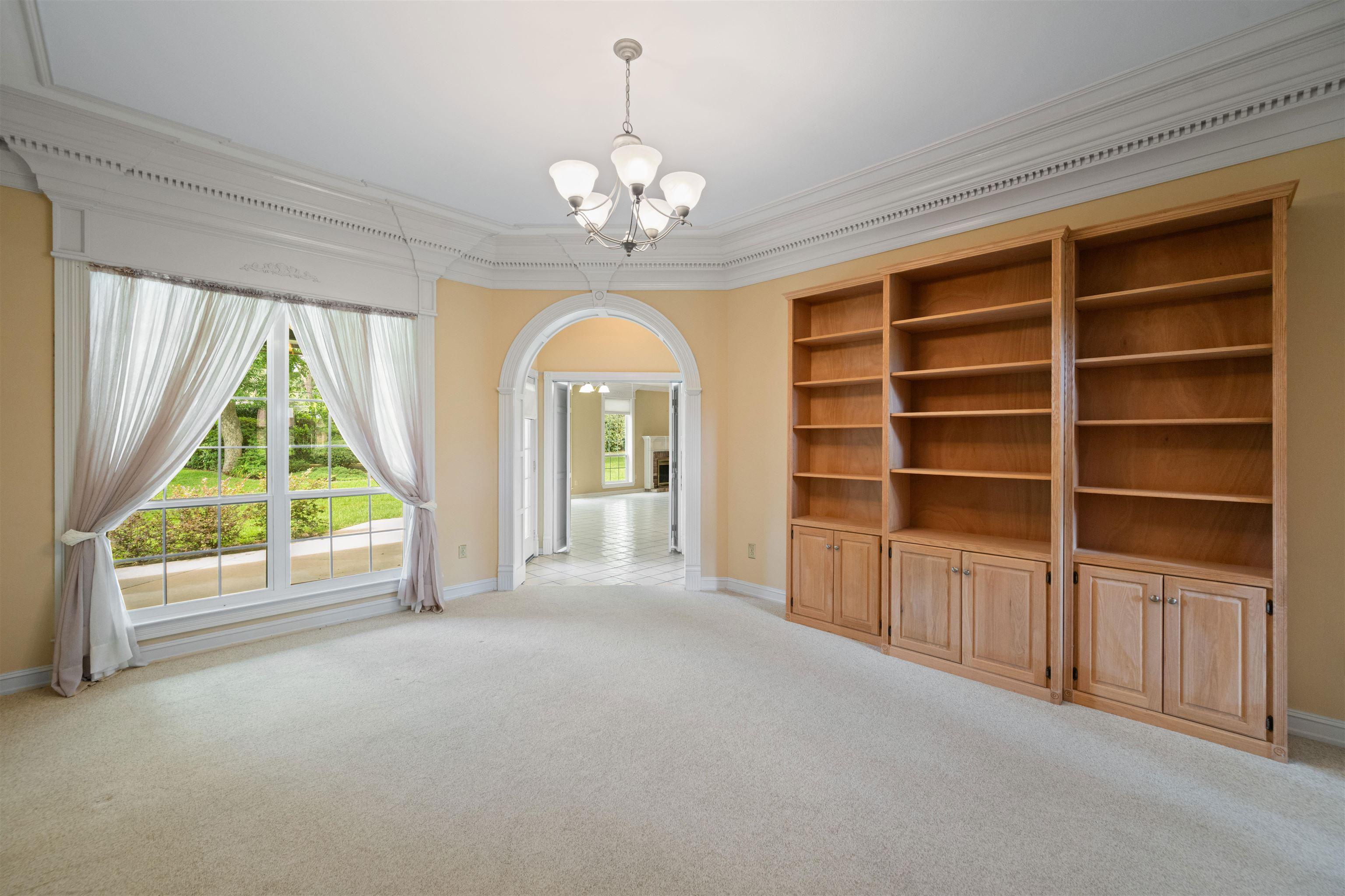 Image 2: Living area number has wooden bookshelves that are not built in but stay with the house., Entry Living Room