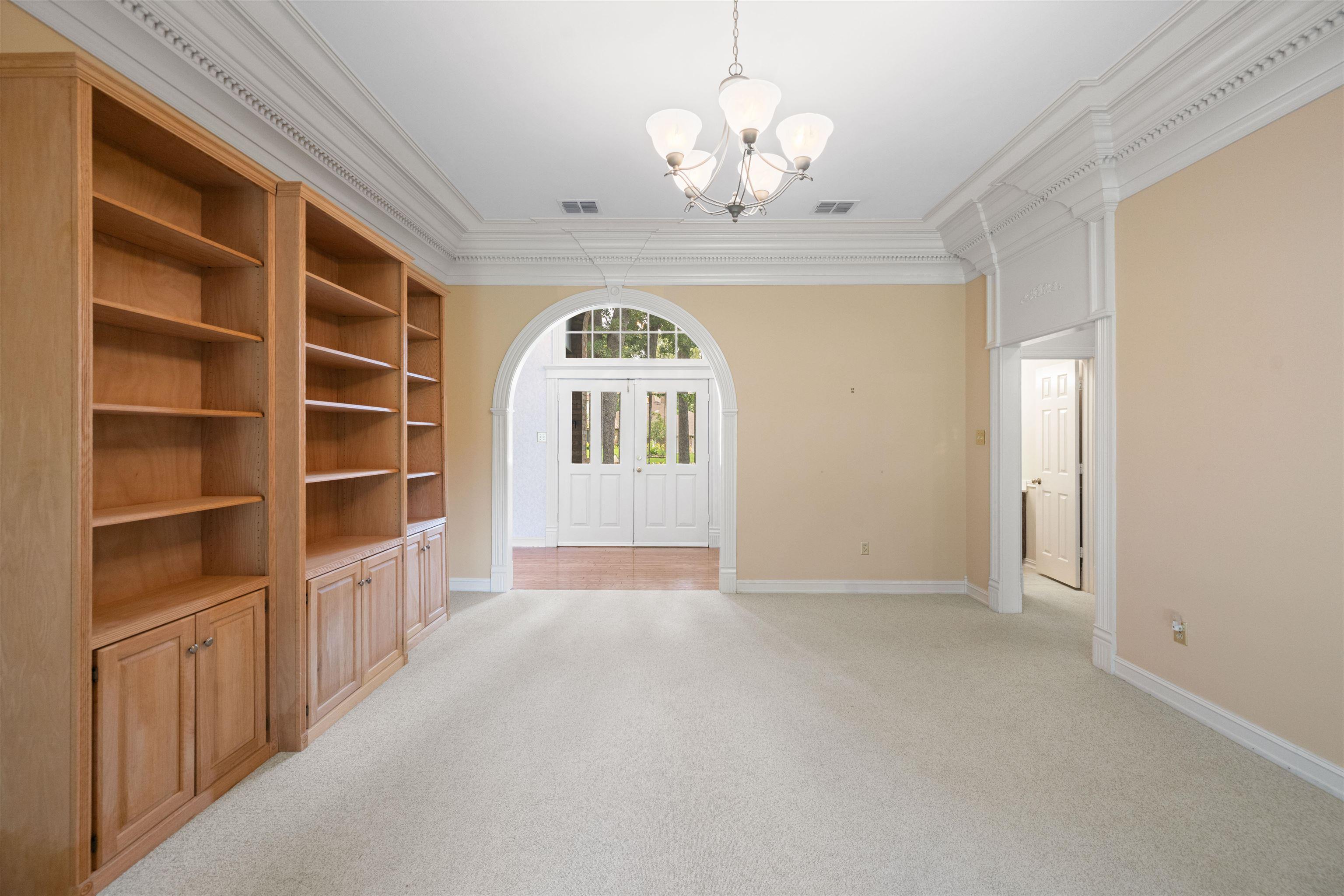 Image 3: Wooden bookshelves are not built in but stay with the house., Entry Living Room