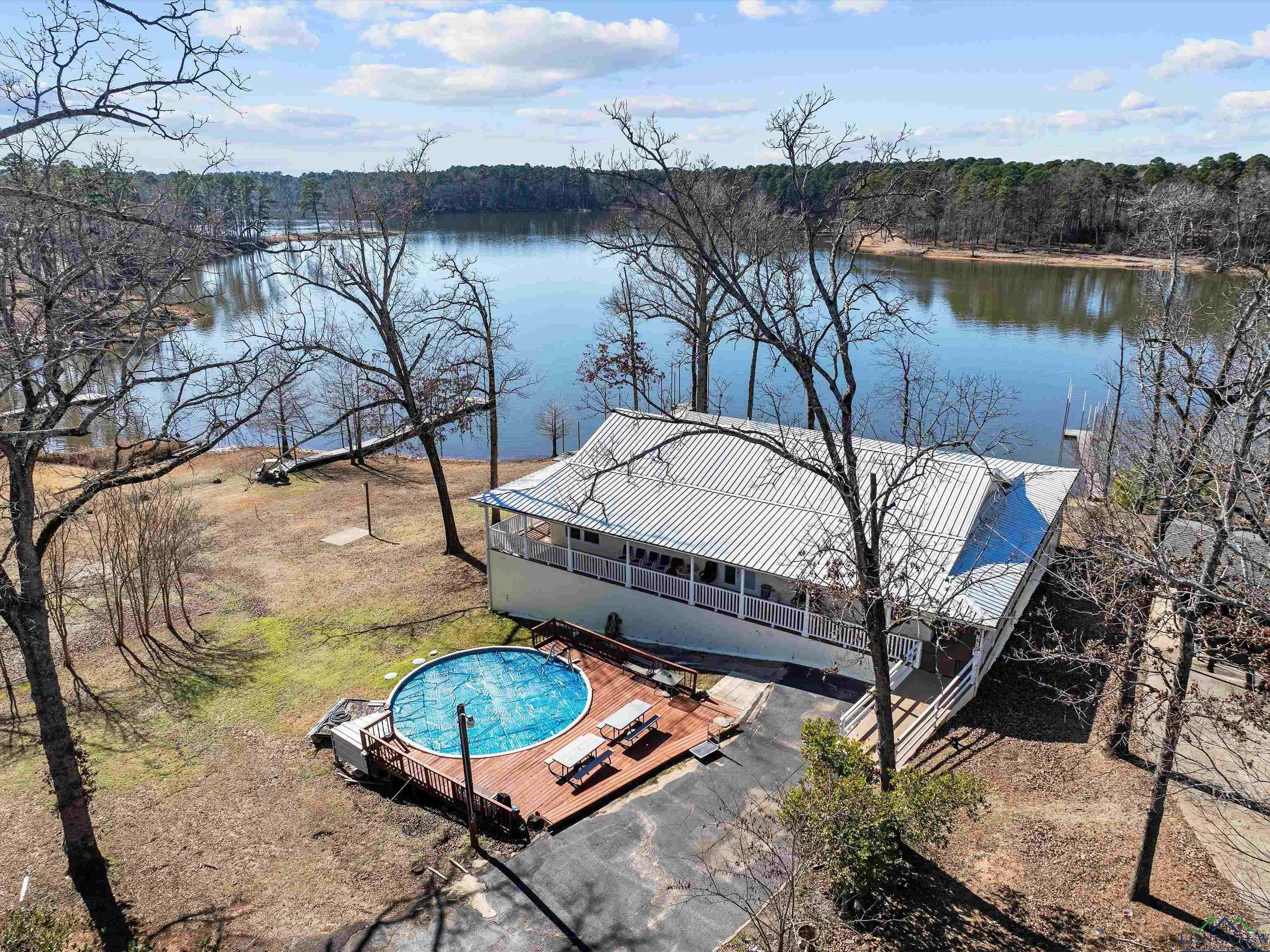 Image 1: Bird's eye view of a pool and a large body of water, Aerial View