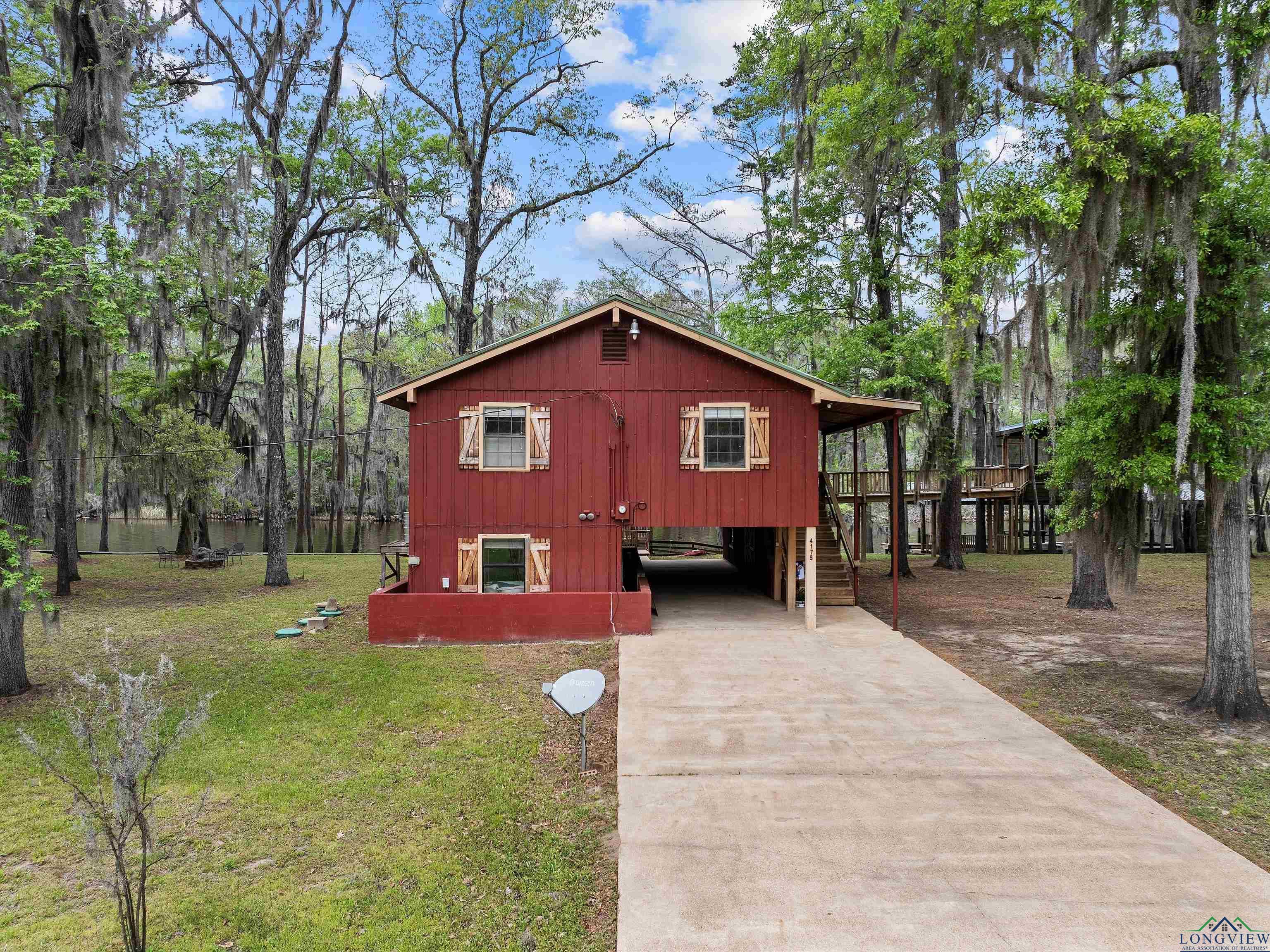 Image 1: View of front of home featuring driveway, a front lawn, and stairway, Front Of Structure