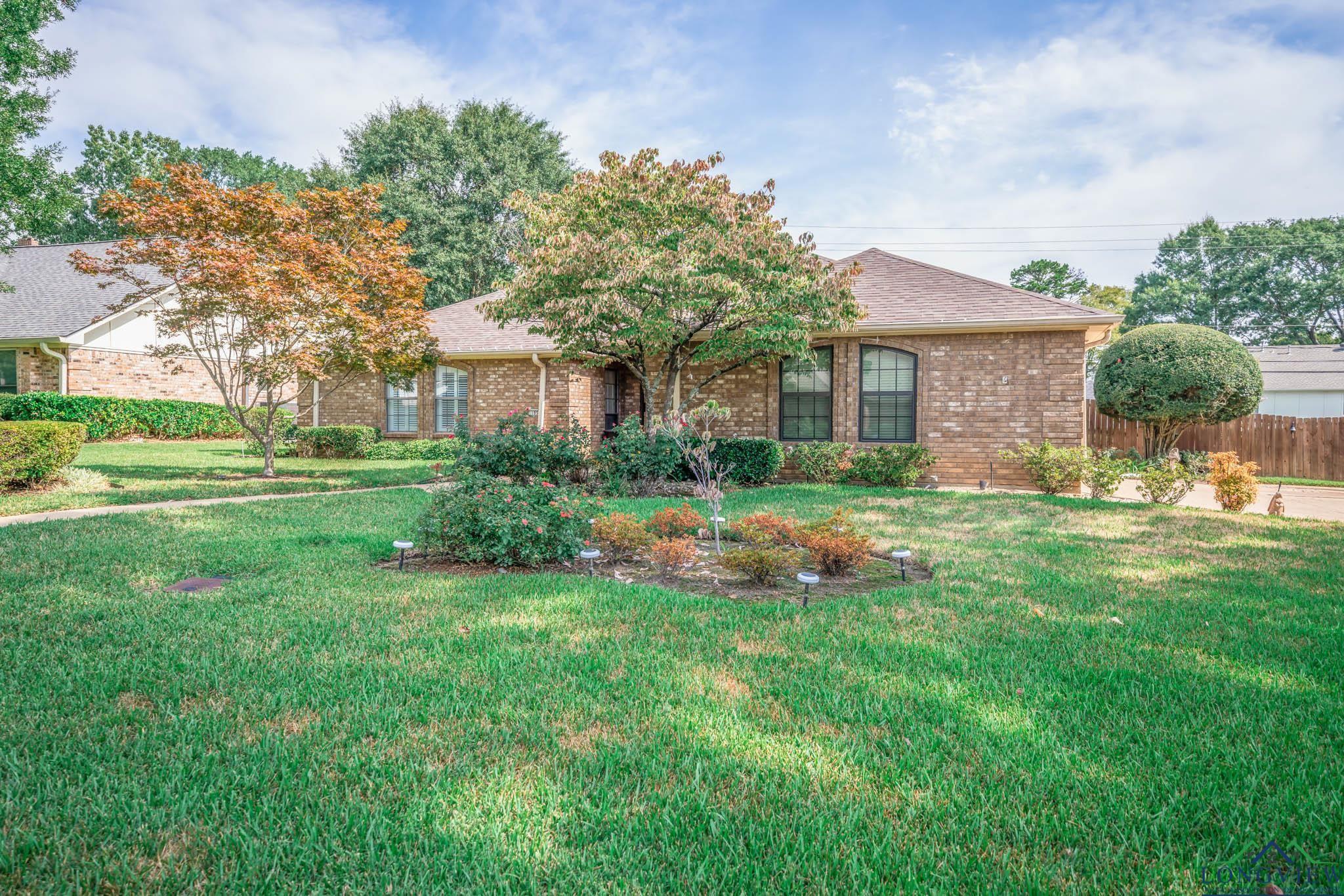 Image 2: View of front of property with brick siding and a shingled roof, Front Of Structure