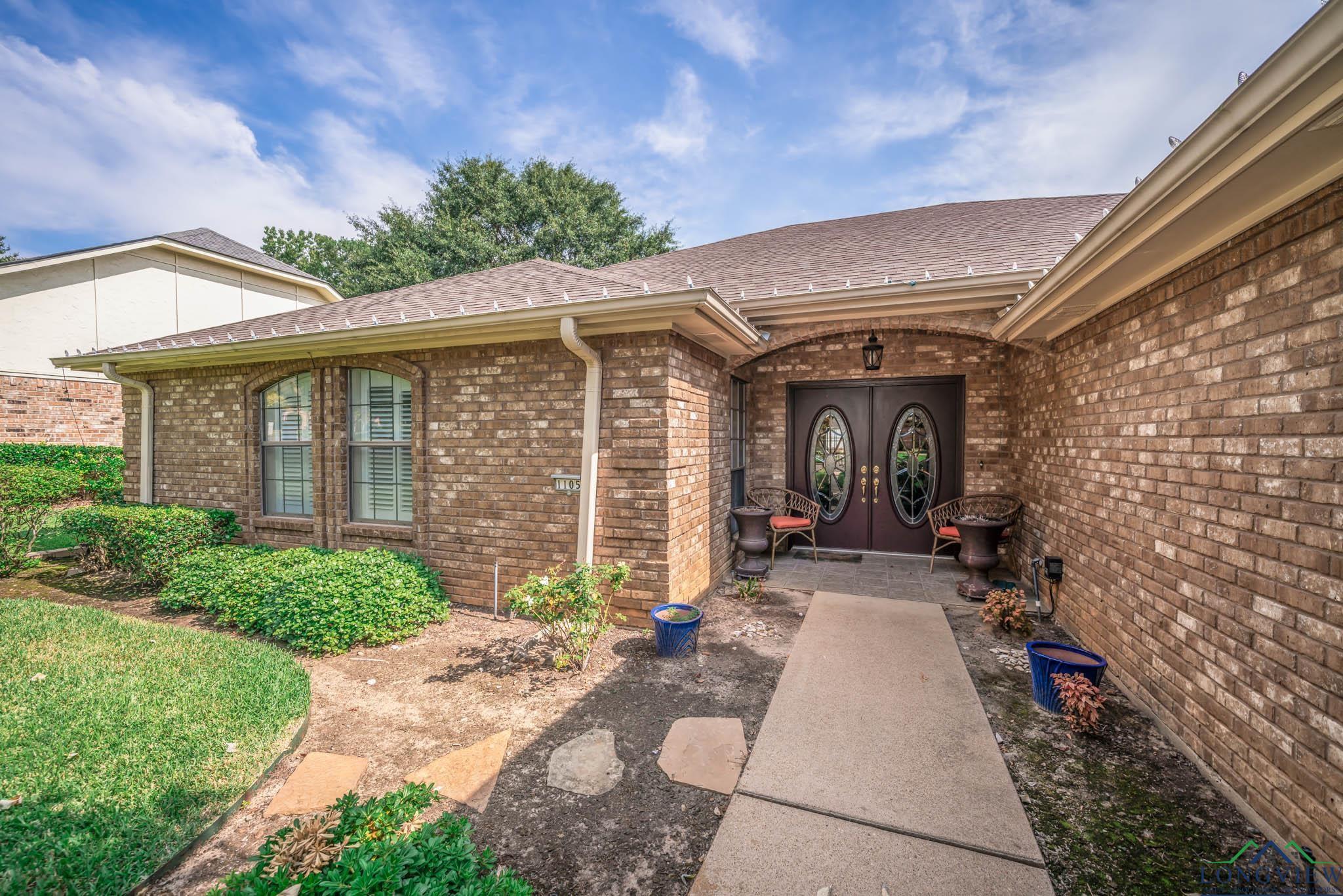 Image 3: Doorway to property featuring a shingled roof, brick siding, and french doors, Entry