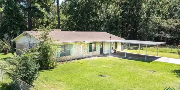 Image 1: Ranch-style house with brick siding, a shingled roof, driveway, and covered porch, Front Of Structure