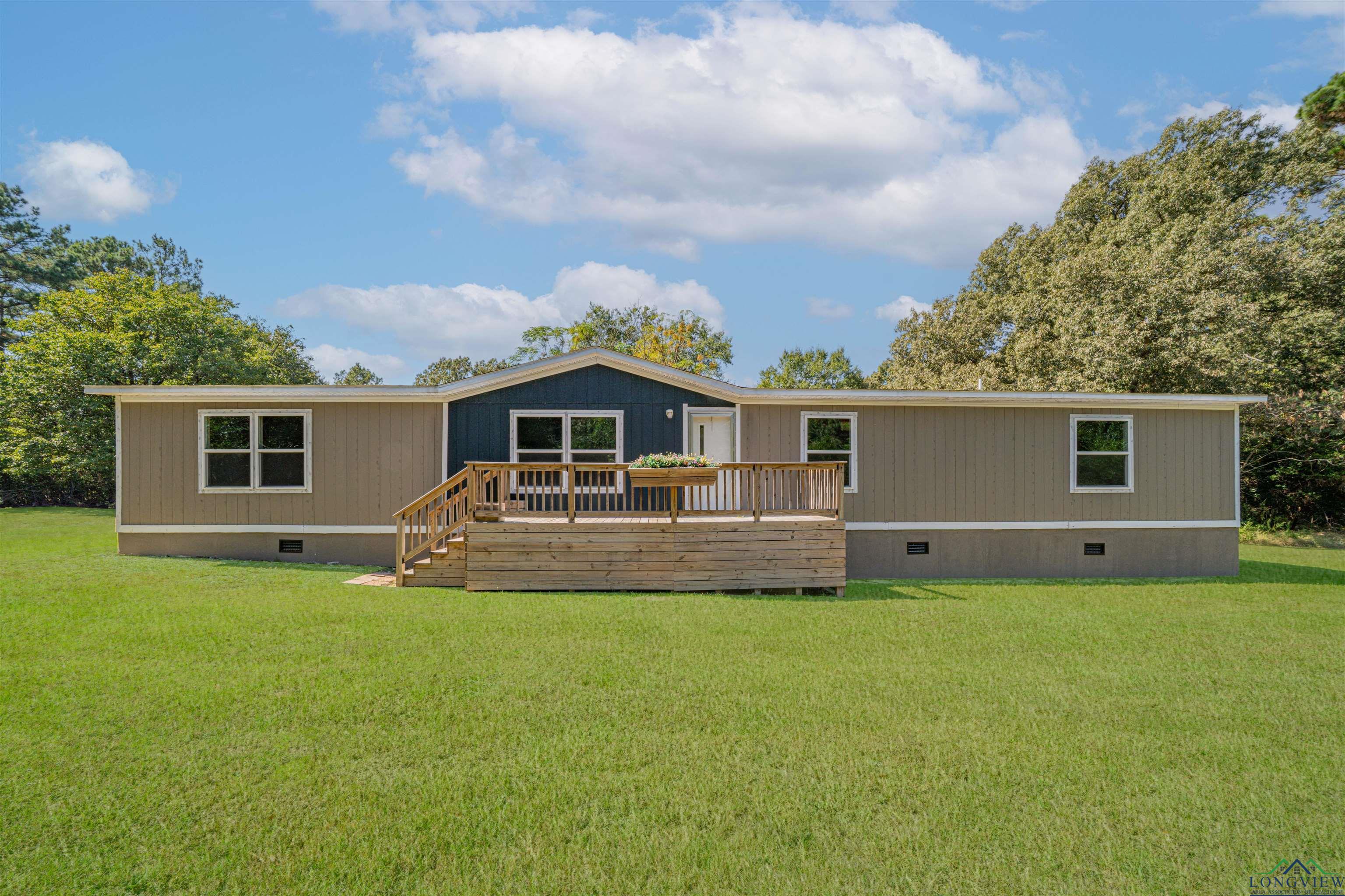 Image 0: Back of house featuring crawl space, a yard, and a deck, Back Of Structure