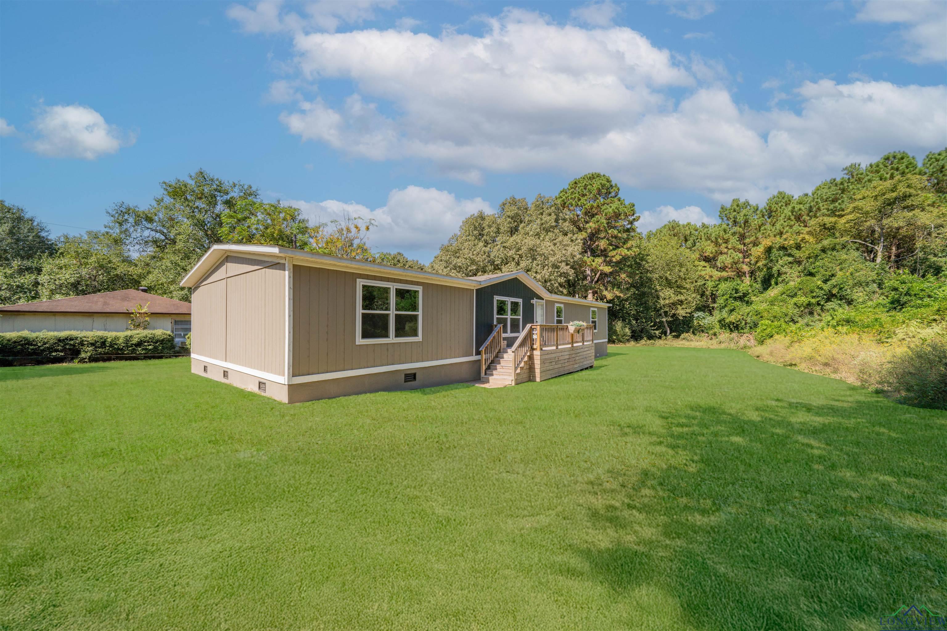 Image 1: Rear view of property with crawl space, a yard, and a deck, Back Of Structure