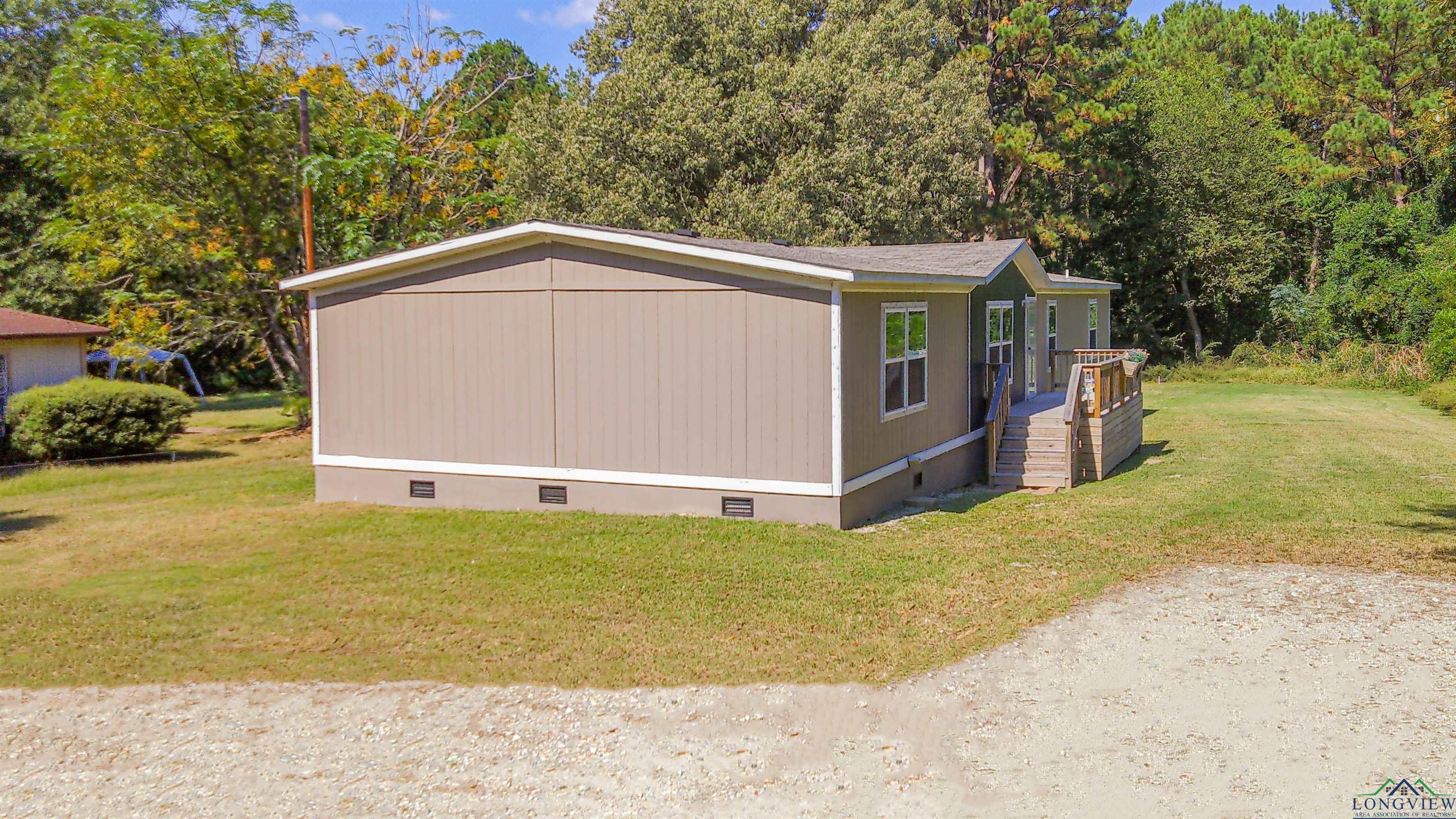 Image 2: View of side of home featuring crawl space and a lawn, Side Of Structure