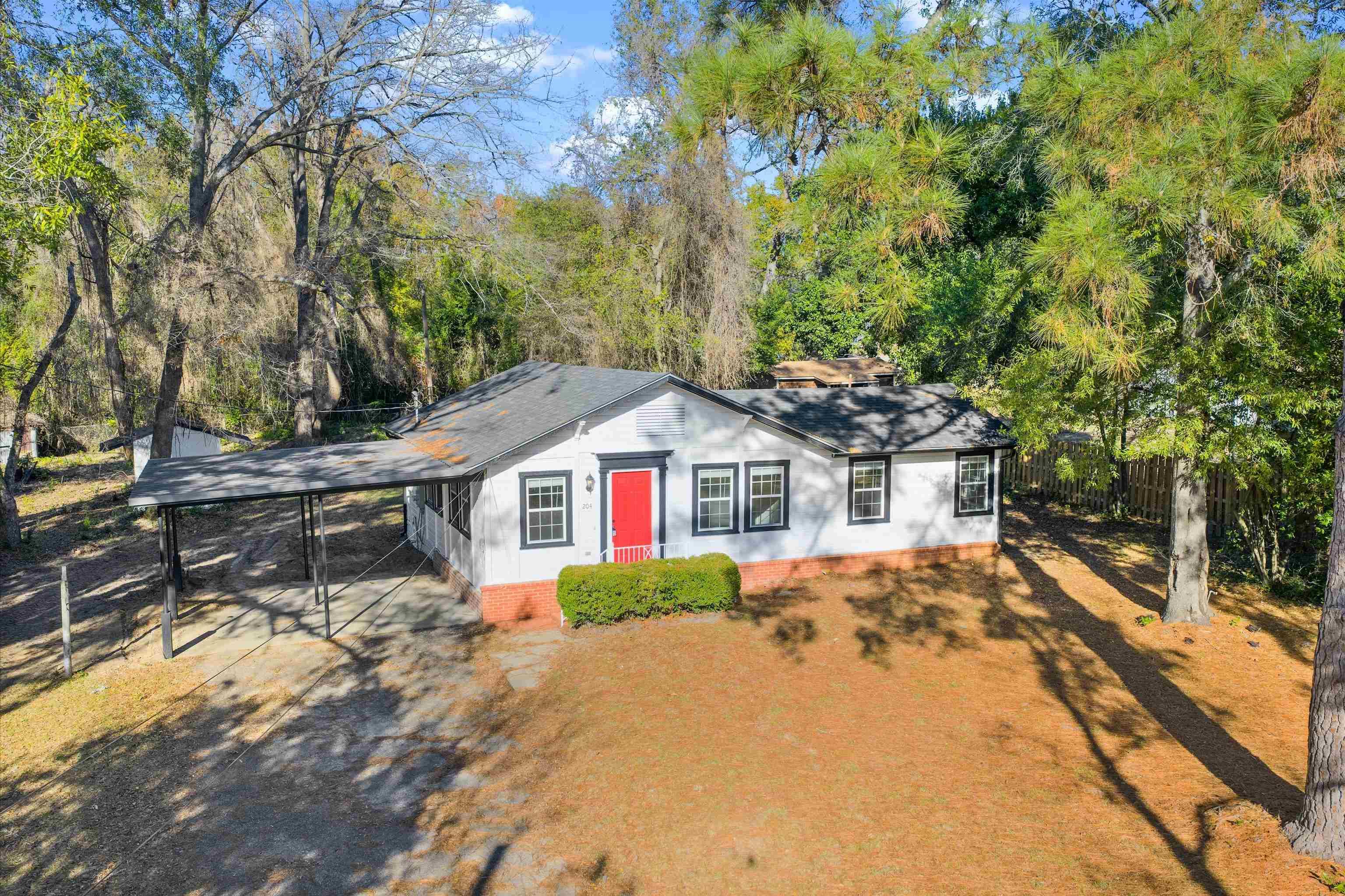 Image 1: View of front of home with an attached carport, roof with shingles, and driveway, Front Of Structure