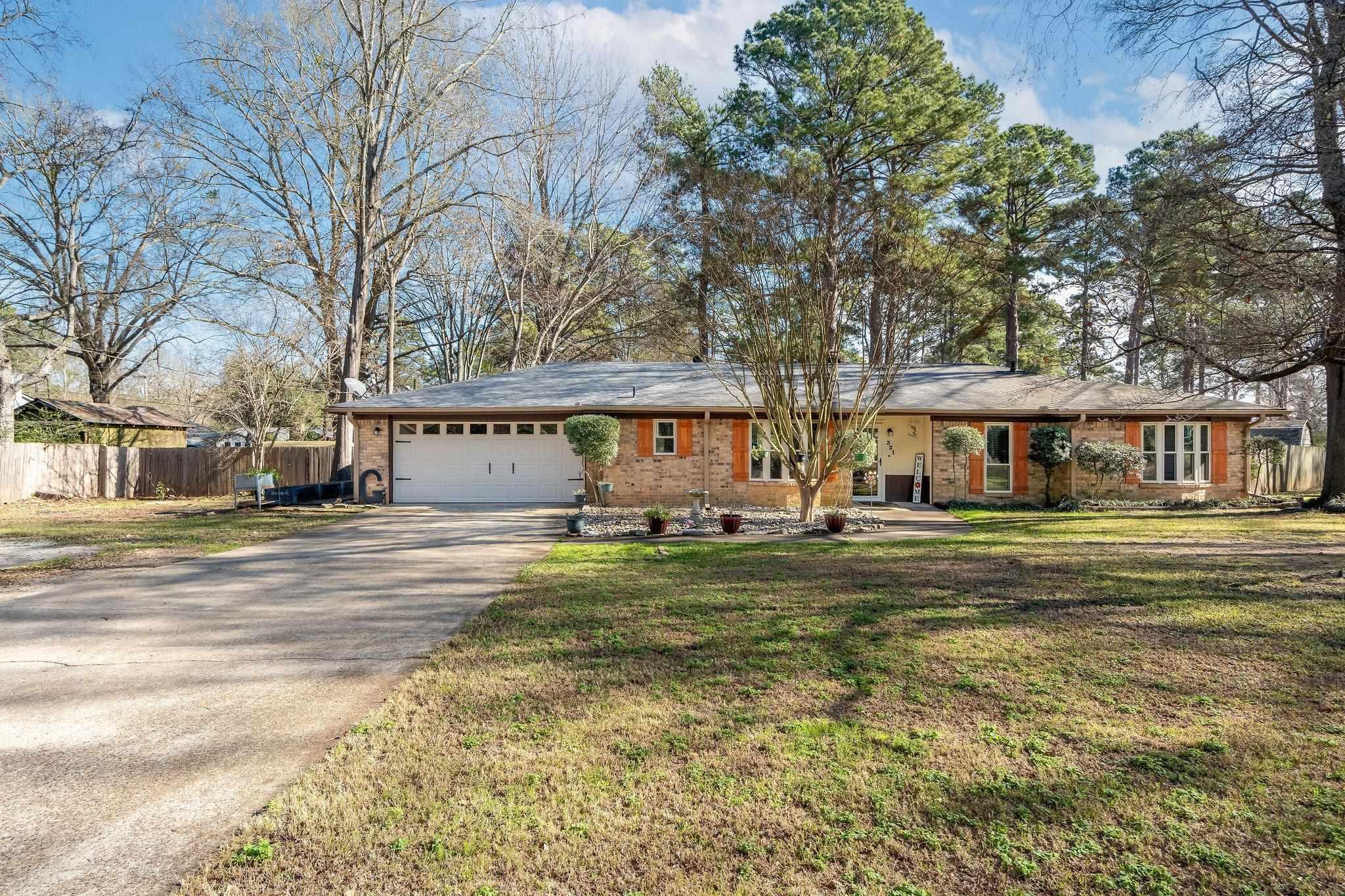 Image 0: Ranch-style house with driveway, brick siding, and a garage, Front Of Structure
