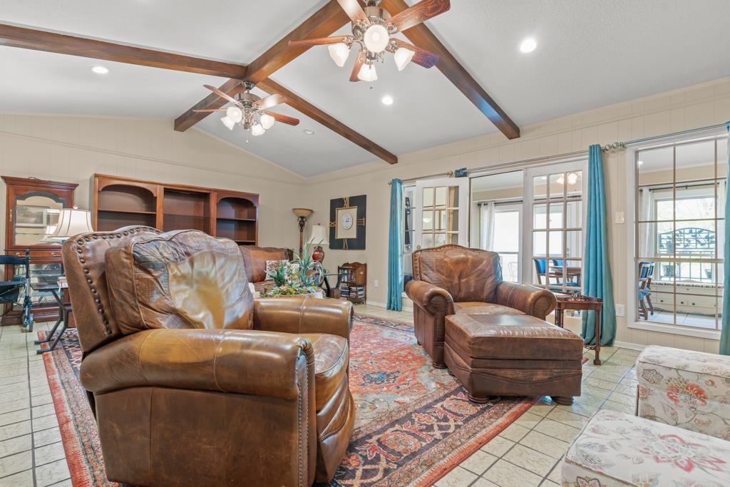 Image 2: Living area featuring a ceiling fan, beamed ceiling, recessed lighting, and light tile patterned flooring, Living Room