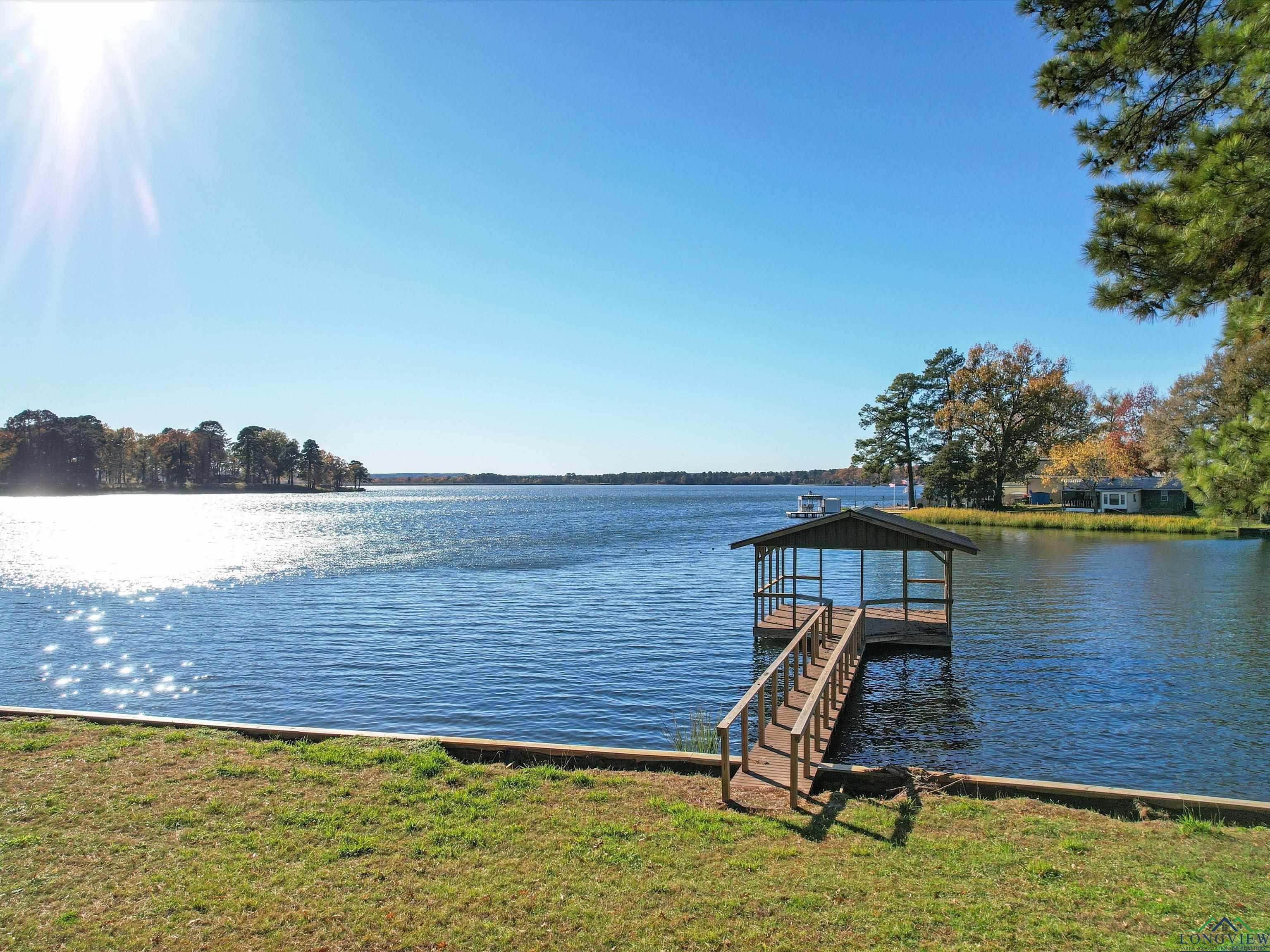 Image 1: Dock area featuring a water view, Dock