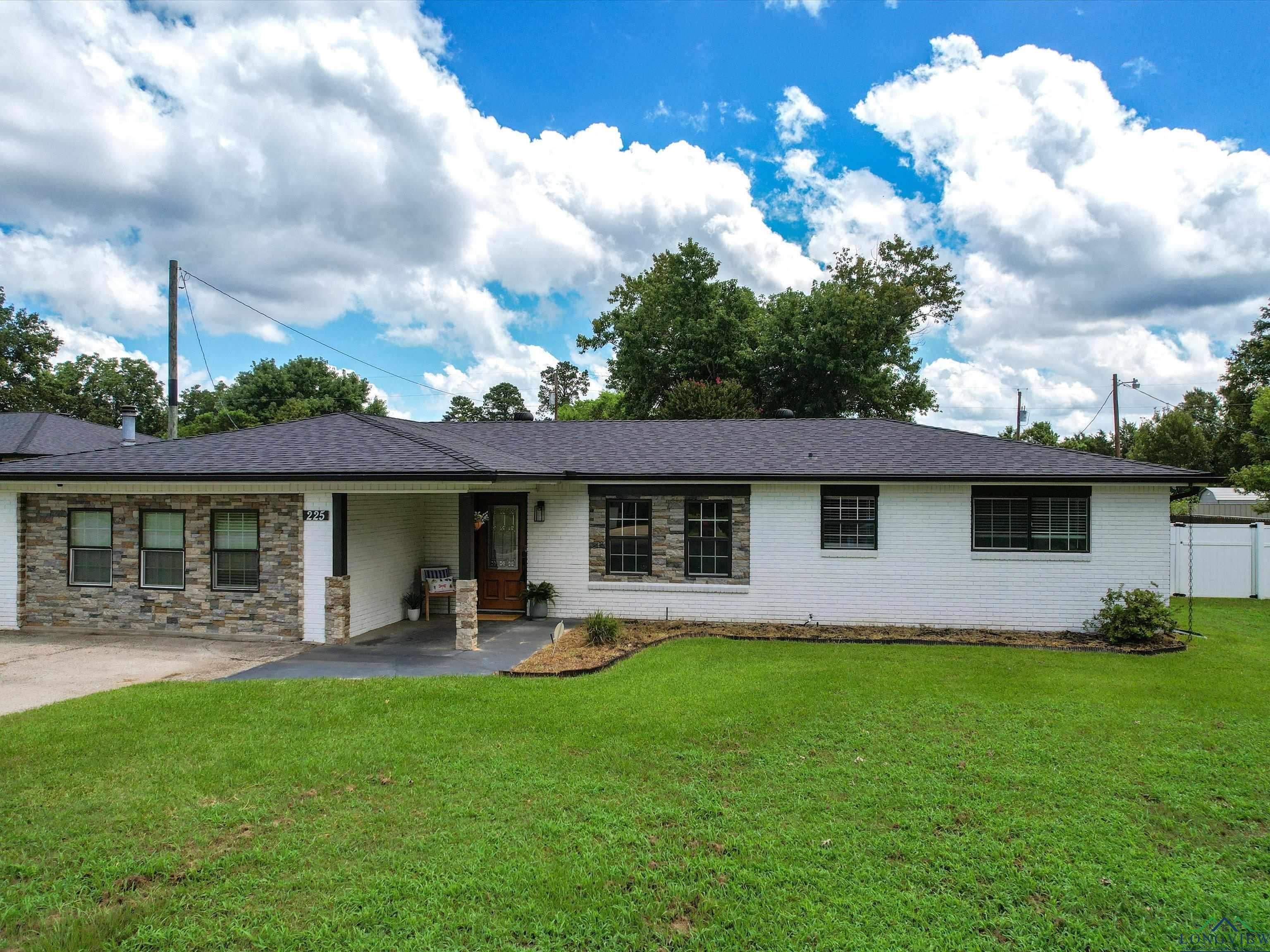 Image 1: Ranch-style home with brick siding and a shingled roof, Front Of Structure