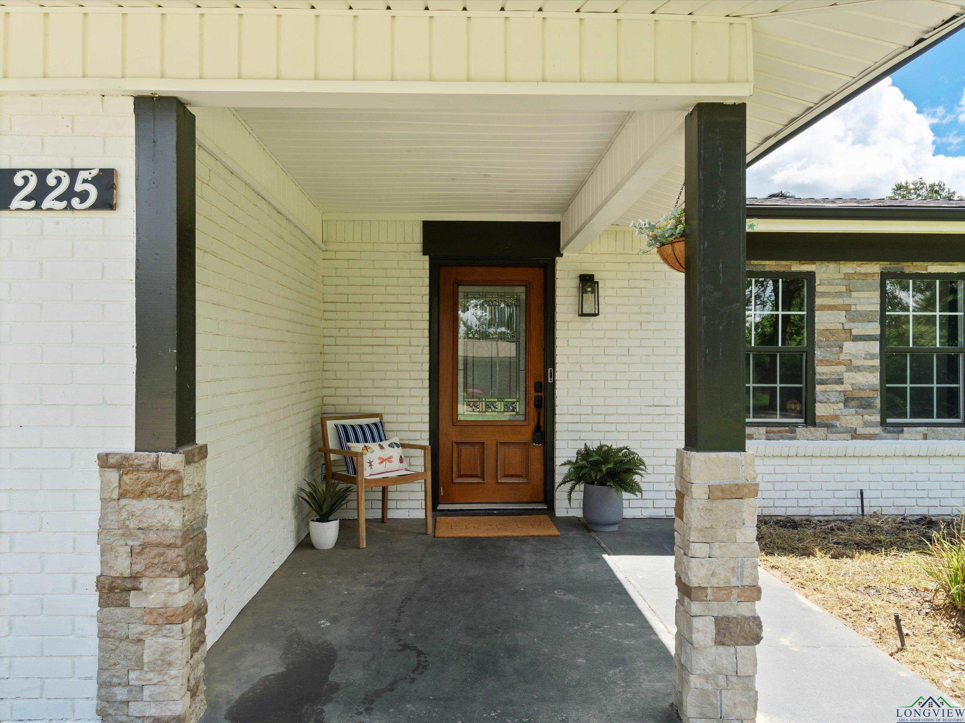 Image 2: Doorway to property featuring brick siding and a porch, Entry