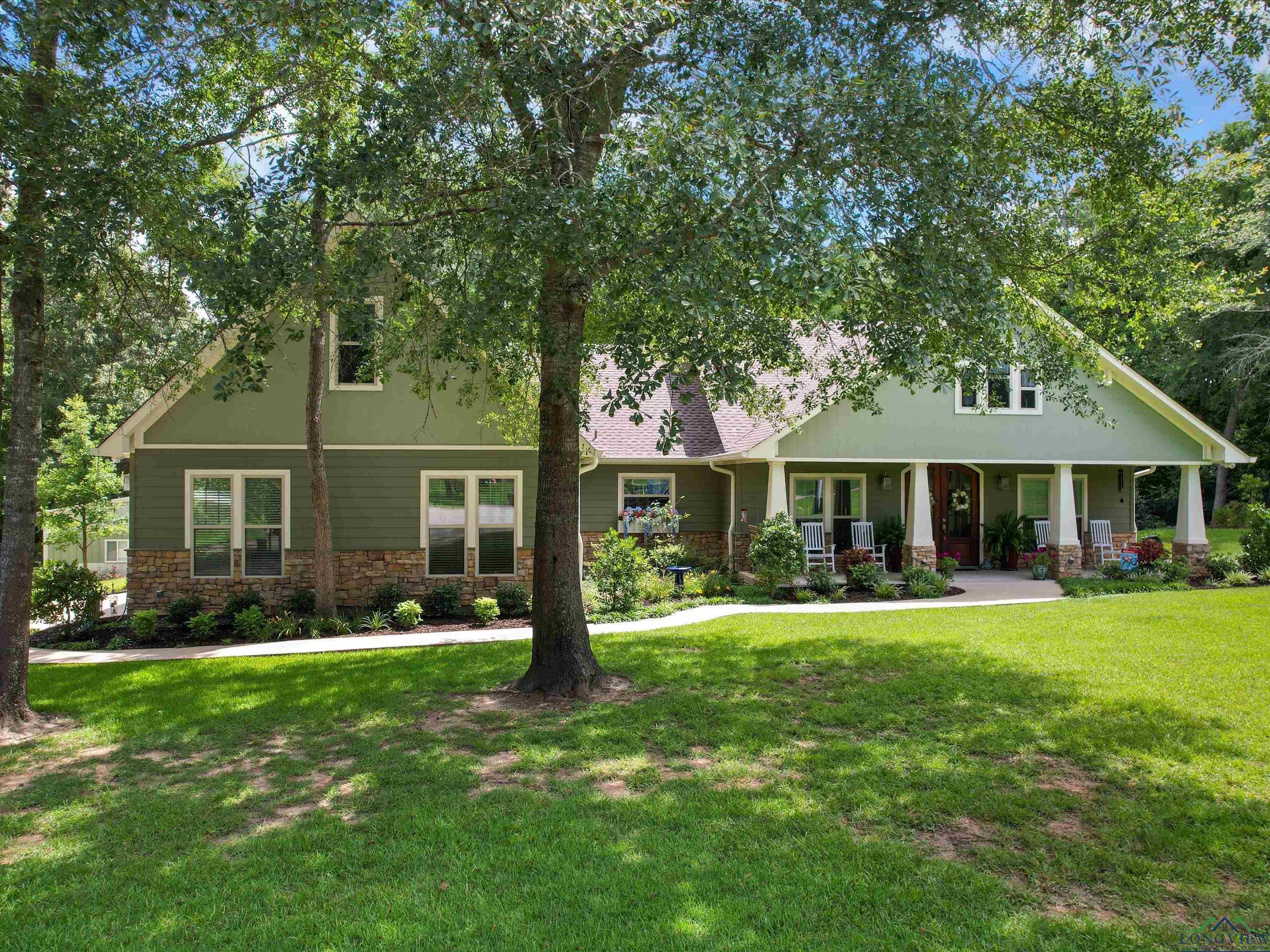 Image 1: Craftsman inspired home with a front lawn, a porch, and stone siding, Front Of Structure