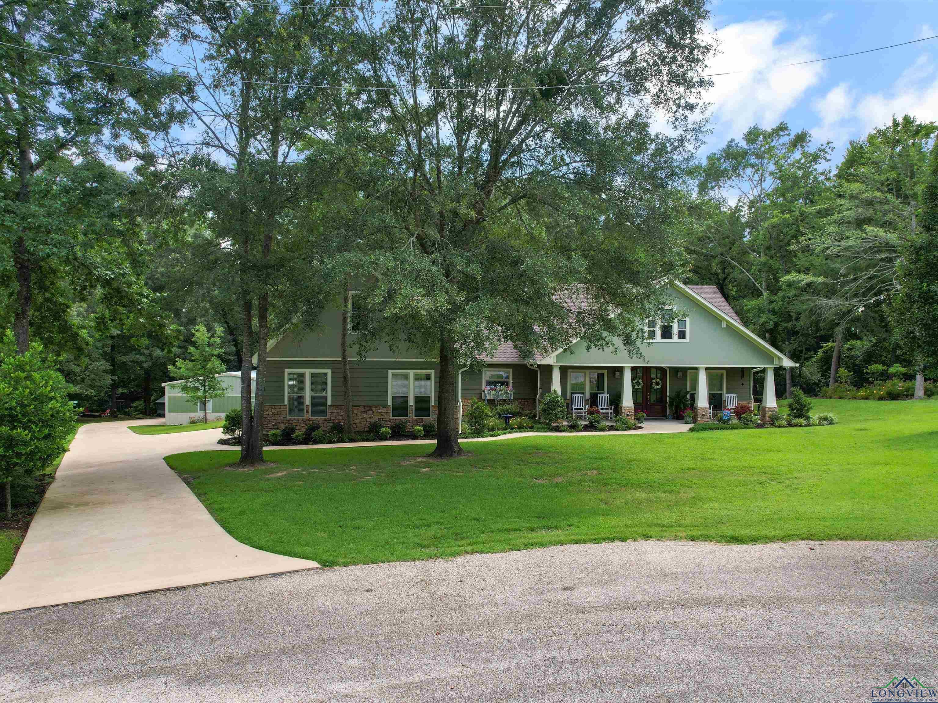 Image 2: View of front facade featuring driveway, a front lawn, and a porch, Front Of Structure