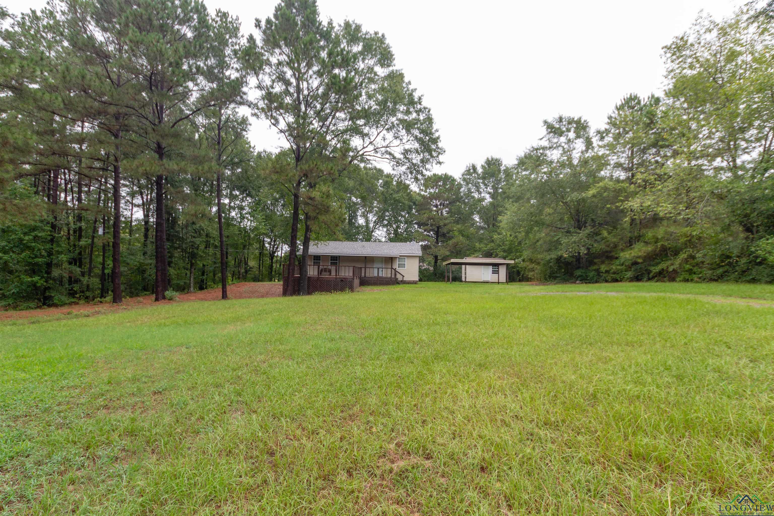 Image 1: View of green lawn with an outdoor structure, Yard